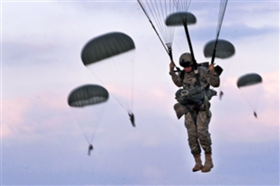 U.S. Army soldiers parachute after jumping from a C-130 Hercules aircraft over Fort Bragg, N.C., Sept. 12, 2010. The soldiers are assigned to the 82nd Airborne Division.
