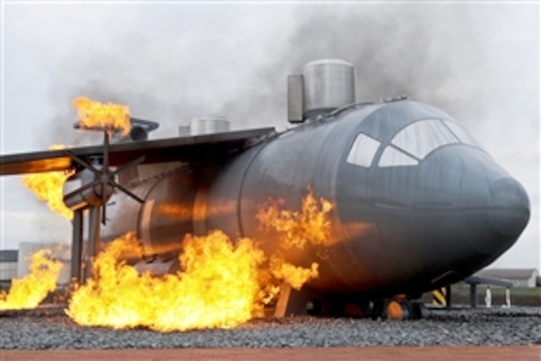 A new training burn site shows an aircraft engulfed in flames for construction team members and fire trainers to view on Ramstein Air Base, Germany, Sept. 9, 2010. The new burn site is the only aircraft training site in Germany.