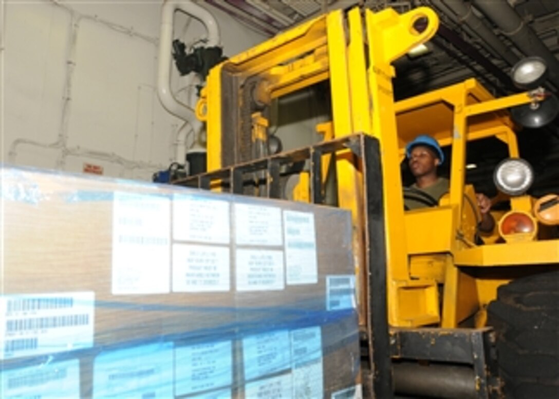 U.S. Marine Corps Lance Cpl. Alex Aikens uses a forklift to pick up humanitarian assistance and disaster relief supplies bound for Pakistan in the well deck of the amphibious assault ship USS Peleliu (LHA 5) in the north Arabian Sea on Aug. 29, 2010.  The Peleliu is the flagship of the Peleliu Amphibious Ready Group providing disaster relief to flooded regions in Pakistan.  