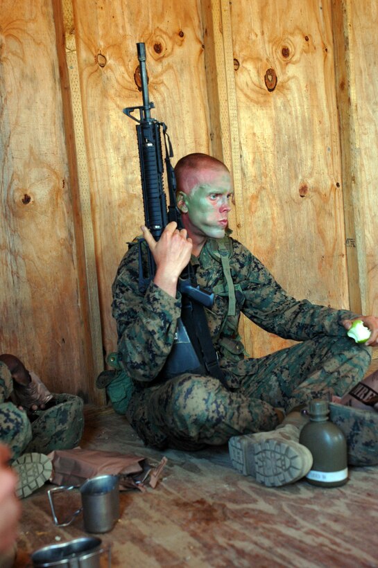 Recruit Bernard D. Lueken, Platoon 3246, Company L, eats an apple after spending all morning executing obstacles during the Crucible at Edson Range, Marine Corps Base Camp Pendleton, Calif., Sept. 14. Lueken played college football for almost two years before he enlisted into the Marine Corps.