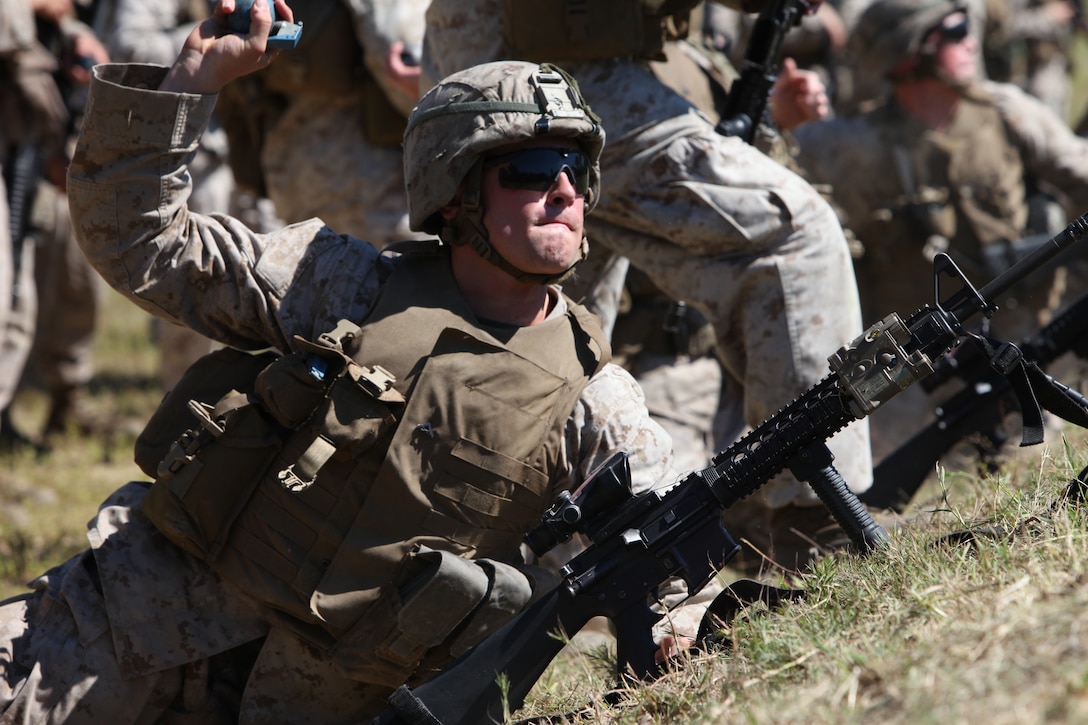 Lance Cpl. Sean P. Abrusci, a Fort Roxbury, N. J. native tosses a M69 practice grenade downrange at the 6N Hand Grenade Range, here, recently.  Before approaching the firing line, all Marines had to demonstrate the proper way to employ the grenade.