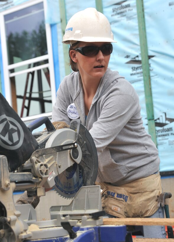 Tech. Sgt. Crystal Perez, of the 932nd Airlift Wing finance office, cuts some wood in support of the Rising Six Habitat for Humanity community project in St. Louis.  Rising Six members volunteered weekends to work on the house buiding effort. (U.S. Air Force photo/Tech. Sgt. Christopher Parr)