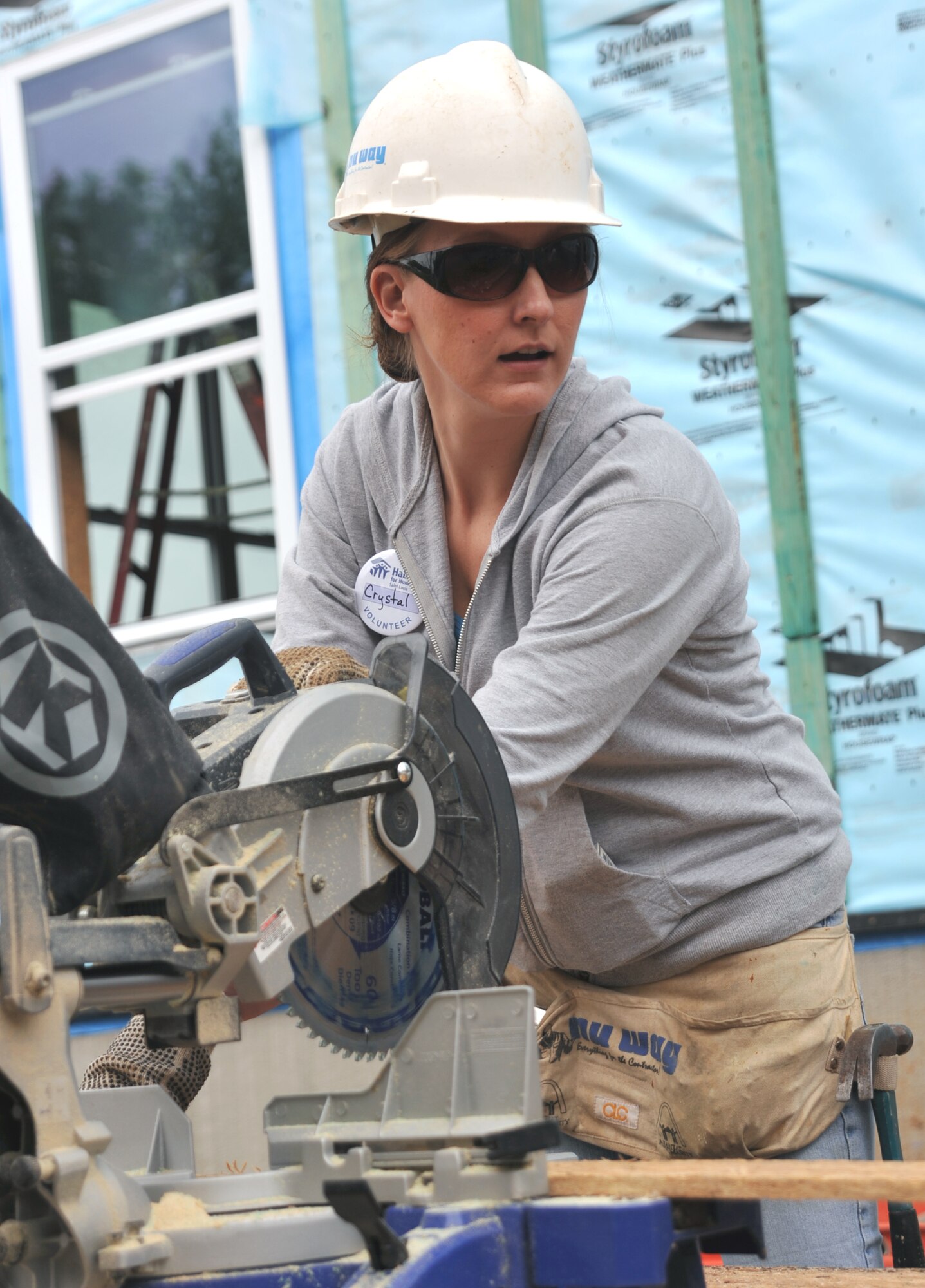 Tech. Sgt. Crystal Perez, of the 932nd Airlift Wing finance office, cuts some wood in support of the Rising Six Habitat for Humanity community project in St. Louis.  Rising Six members volunteered weekends to work on the house buiding effort. (U.S. Air Force photo/Tech. Sgt. Christopher Parr)