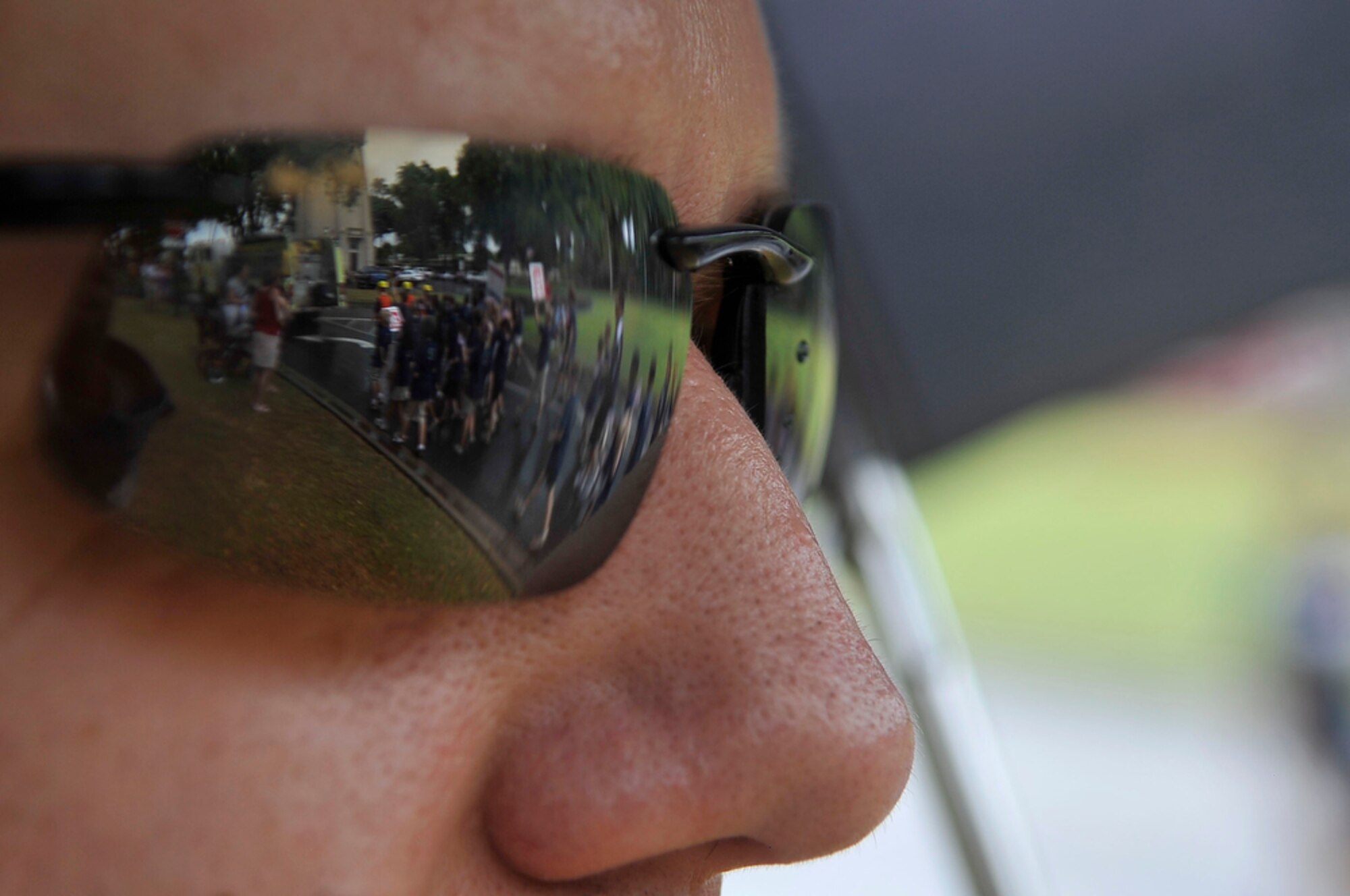 JOINT BASE PEARL HARBOR-HICKAM, Hawaii - Technical Sergeant Keith Cedergren stands by and watches the students of Hickam Elementary School, Joint Base Pear Harbor-Hickam, Hawaii proudly march in a parade on Sept. 10 as part of the school's Second Annual 9/11 Observance Ceremony. More than 750 students from Hickam Elementary participated in the ceremony with the help of their teachers, parents and the Radford High School Color Guard and Band. (U.S.  Air Force photo/Tech Sgt. Cohen A. Young)