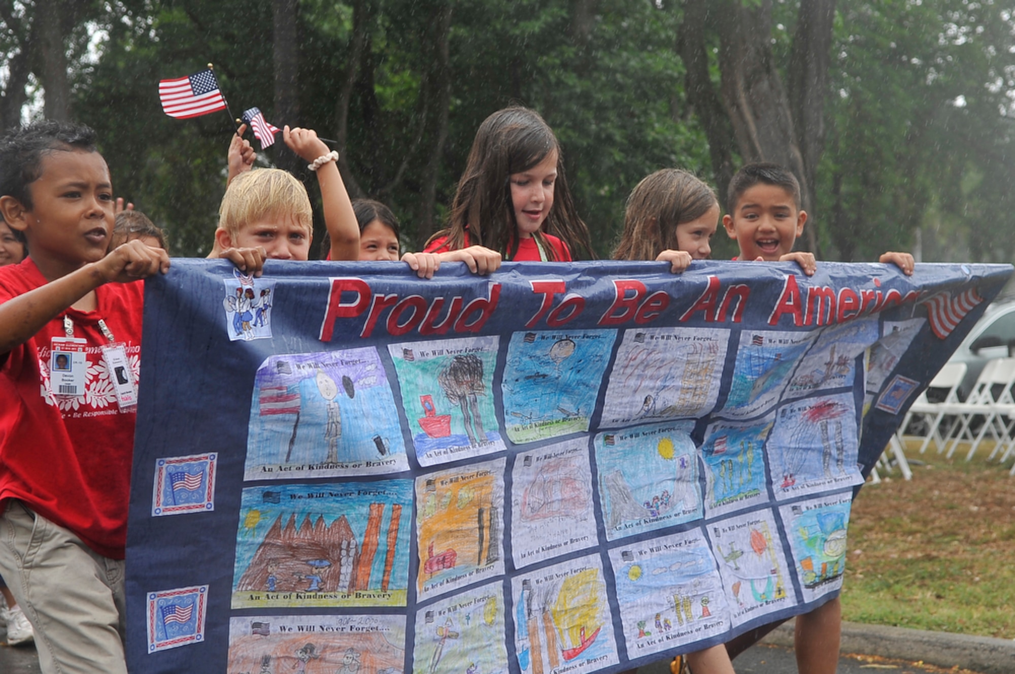 JOINT BASE PEARL HARBOR-HICKAM, Hawaii - Students from Hickam Elementary School, Joint Base Pear Harbor-Hickam, Hawaii proudly hold their banner during their school's parade on Sept. 10 as part of their Second Annual 9/11 Observance Ceremony. More than 750 students from Hickam Elementary participated in the ceremony with the help of their teachers, parents and the Radford High School Color Guard and Band. (U.S.  Air Force photo/Tech Sgt. Cohen A. Young)