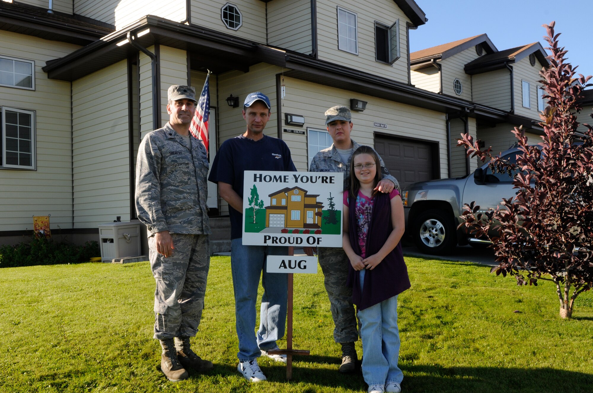 Tech. Sgt. Yolanda Quinlivan and family display their "Home You're Proud Of" award with 354th Civil Engineer Squadron commander Lt. Col. Michael Sheredy Sept.10, 2010, Eielson Air Force Base, Alaska.  Each winning household recieves gift cards from various units on base and businesses off base. Sergeant Quinlivan is assigned to the 354th Medical Operations Squadron. (U.S. Air Force photo/Airman 1st Class Yash Rojas)