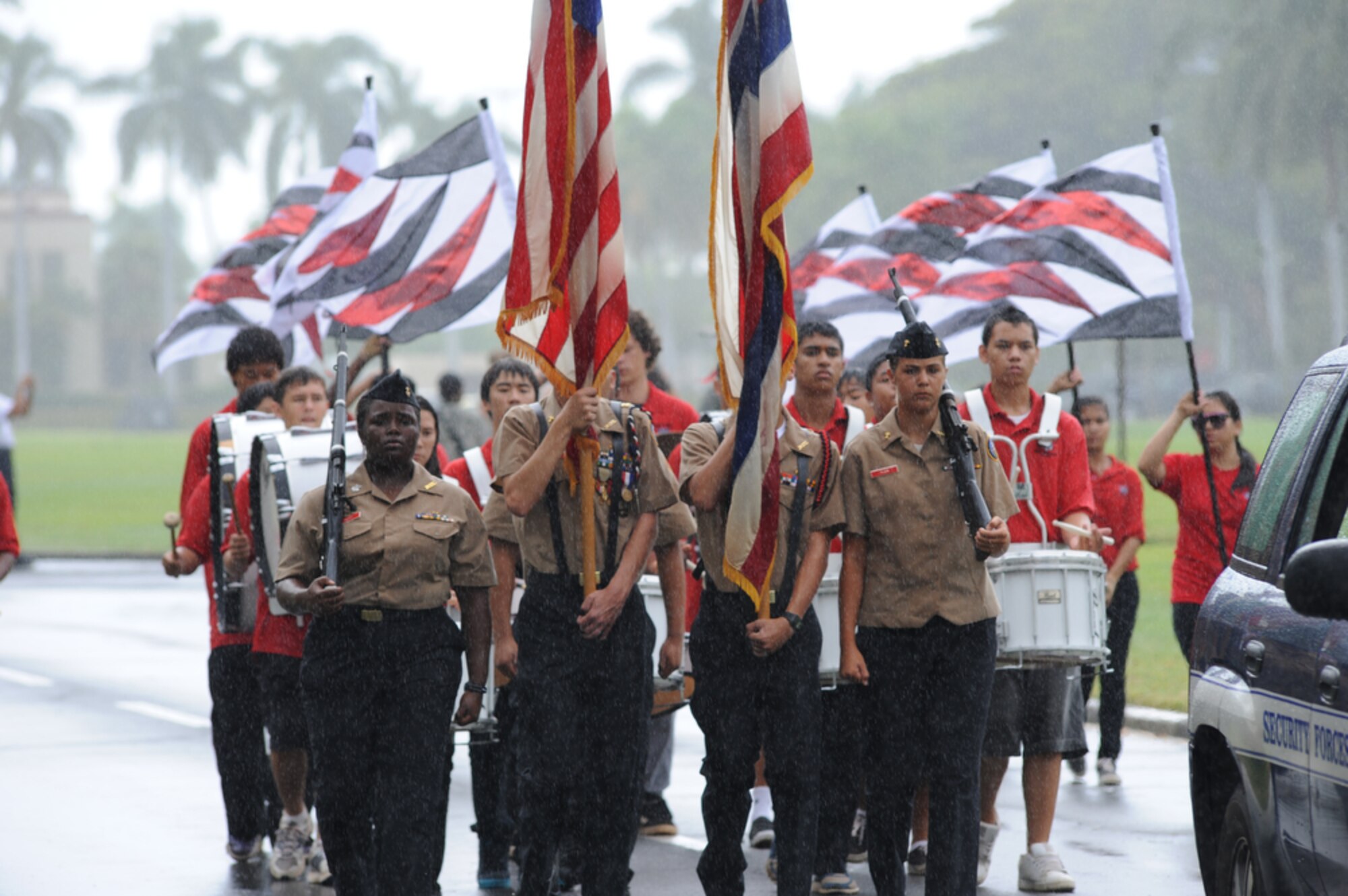 JOINT BASE PEARL HARBOR-HICKAM, Hawaii - The Radford High School Color Guard marches in the rain  as part of Hickam Elementary School's 9/11 Observance Ceremony held at Joint Base Pear Harbor-Hickam, Hawaii on Sept. 10. More than 750 students from Hickam Elementary participated in the ceremony with the help of their teachers, parents, the Fire Dept., Security Forces and the Radford High School Color Guard and Band. (U.S.  Air Force photo/Tech Sgt. Cohen A. Young)