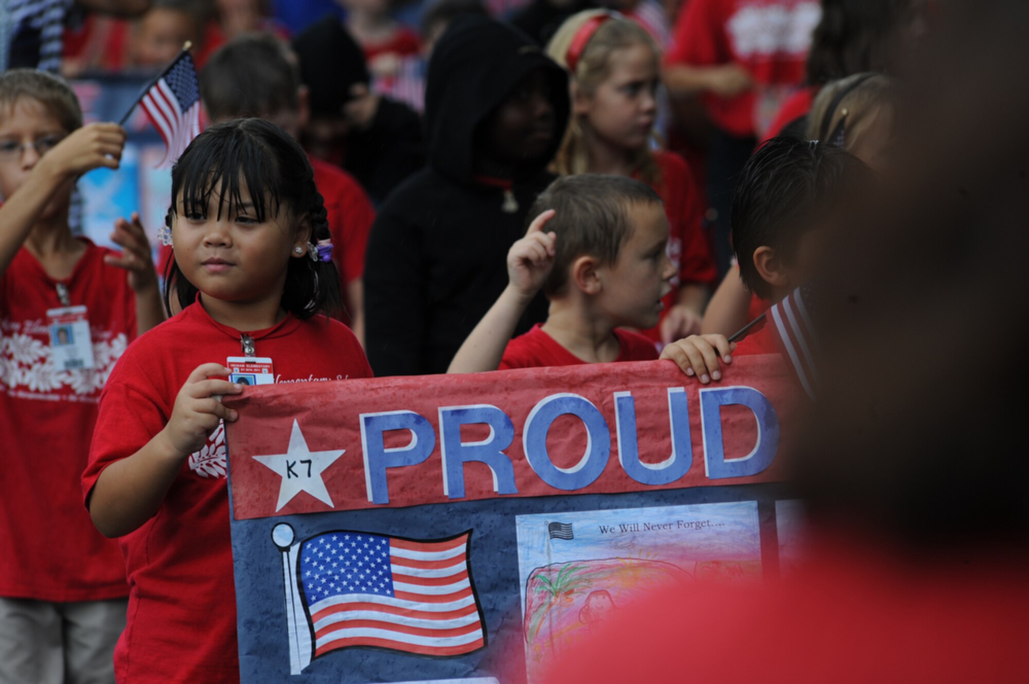 JOINT BASE PEARL HARBOR-HICKAM, Hawaii - A second grader from Hickam Elementary School, Joint Base Pear Harbor-Hickam, Hawaii looks off into the crowd while she marches and holds her banner during her school's parade on Sept. 10 as part of their Second Annual 9/11 Observance Ceremony. More than 750 students from Hickam Elementary participated in the ceremony with the help of their teachers, parents and the Radford High School Color Guard and Band. (U.S.  Air Force photo/Tech Sgt. Cohen A. Young)
