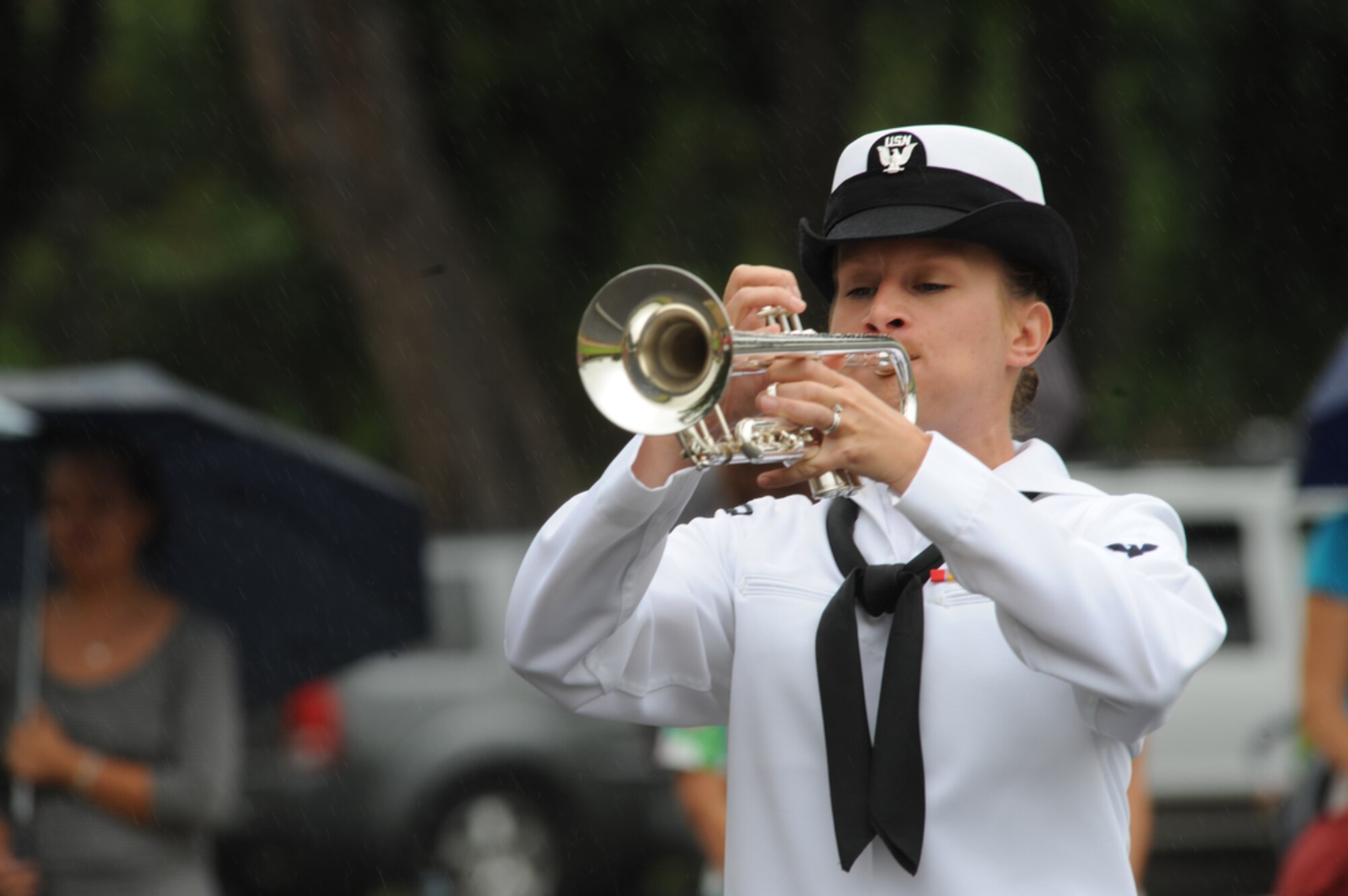 JOINT BASE PEARL HARBOR-HICKAM, Hawaii - Pacific Fleet Band member, Musician Second Class Kristen Snitzer, a native of Rochester, N.Y. plays "Taps" while being rained on during a 9/11 Ceremony at Hickam Elementary School, Joint Base Pear Harbor-Hickam, Hawaii on Sept. 10. More than 750 students from Hickam Elementary School  with the help of their teachers, parents, MU2 Snitzer and the Radford Band took time to remember those that were killed as a result of several terrorists acts on Sept. 11, 2001. (U.S.  Air Force photo/Tech Sgt. Cohen A. Young)
