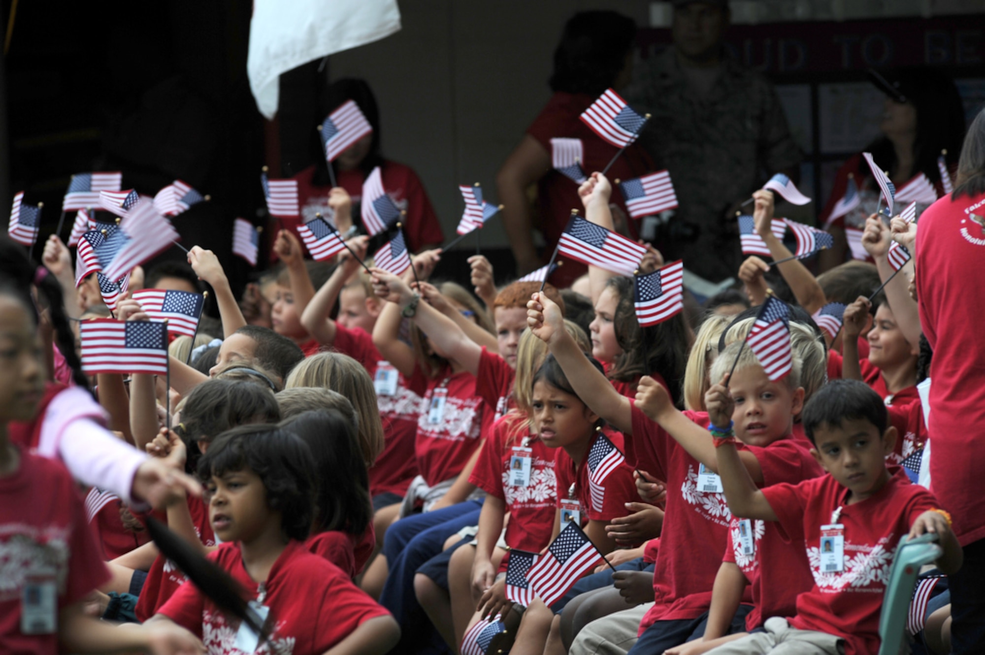 JOINT BASE PEARL HARBOR-HICKAM, Hawaii - Students from Hickam Elementary School wave their flags proudly on Sept. 10 during a 9/11 Ceremony on Joint Base Pearl Harbor-Hickam, Hawaii. This is the school's second year paying respect to the victims of the Sept. 11 terrorist attacks that devastated the United States nine years ago. (U.S.  Air Force photo/Tech Sgt. Cohen A. Young)