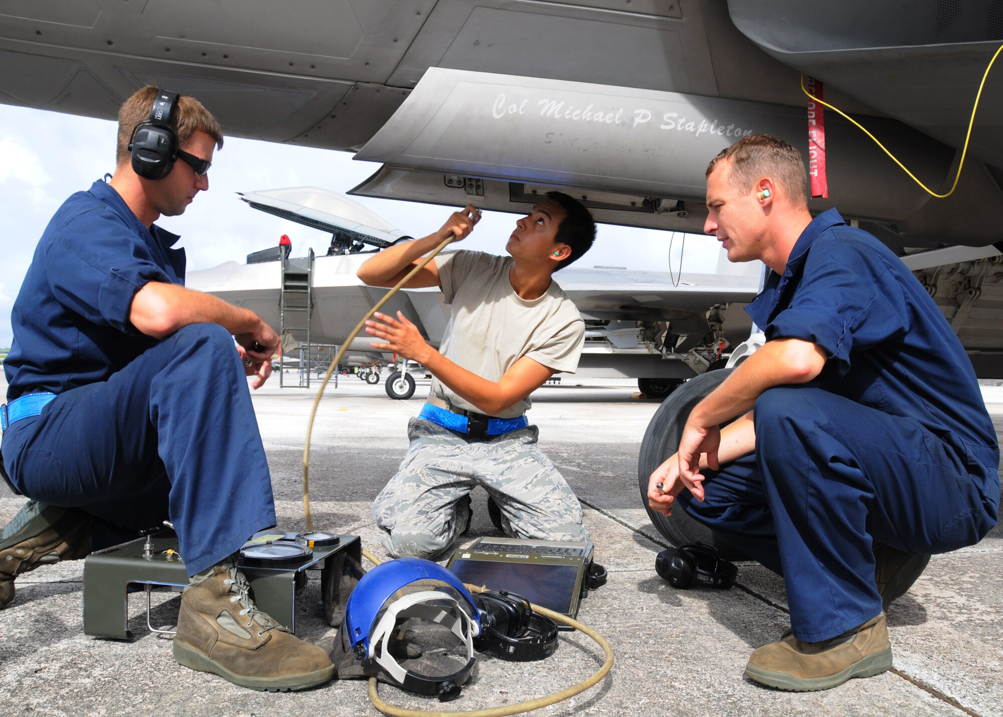 ANDERSEN AIR FORCE BASE, Guam - Crew chiefs Staff Sgt. Zachary Braddock, Airman 1st Class Ryan Pottmeyer and Airman 1st Class Jonathon Sladek, conduct routine maintenance on an F-22 Raptor here Sept. 13. The Airmen are from the 49th Air Craft Maintenance Squadron, Holloman Air Force Base, N.M., are participating in Valiant Shield 2010, a U.S. Pacific Command exercise, from September 12 to 21. The exercise focuses on integrated joint training and interoperability among U.S. military forces while responding to a range of mission scenarios. (U.S. Air Force photo by Senior Airman Nichelle Anderson)
