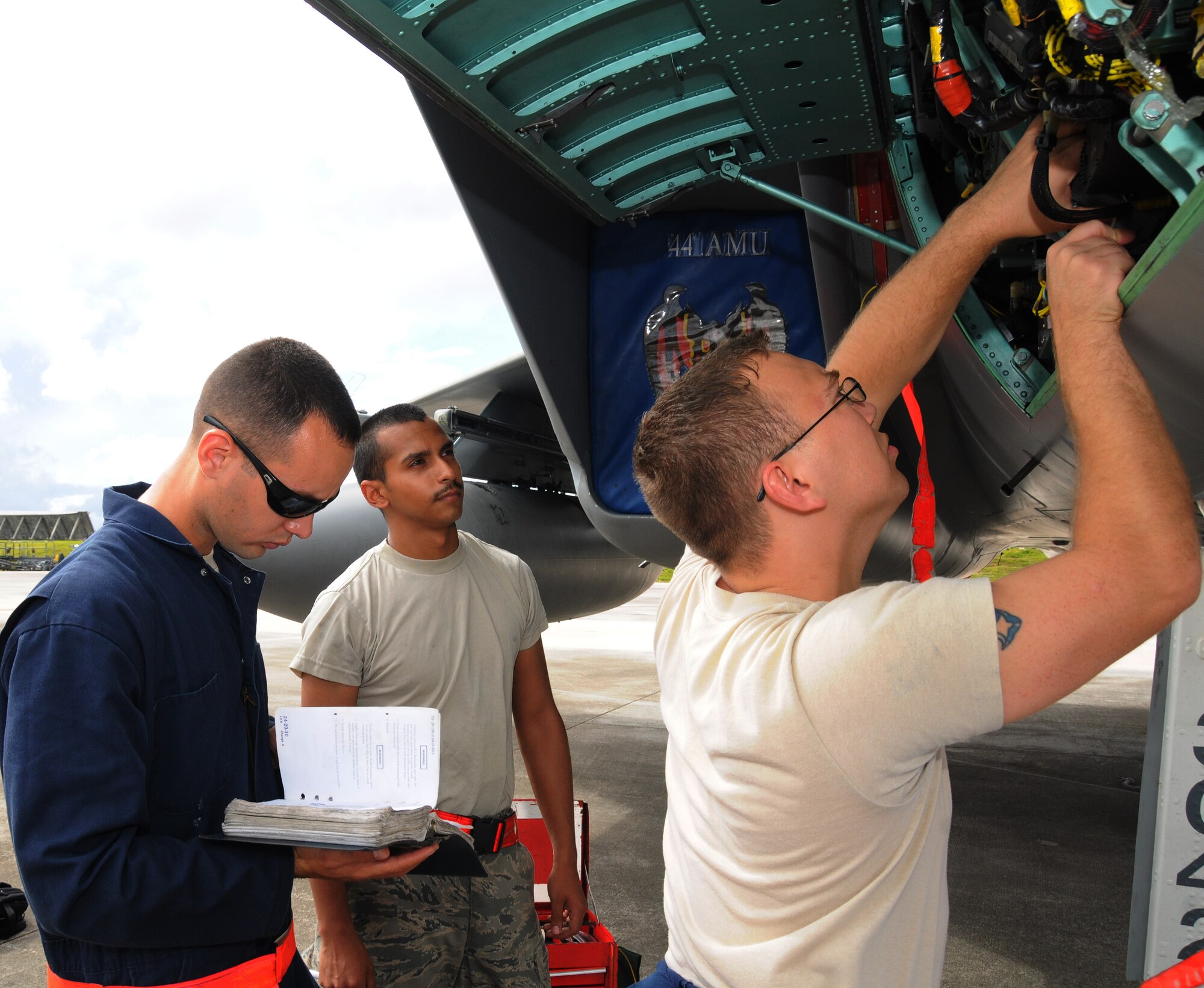 ANDERSEN AIR FORCE BASE, Guam - Senior Airman Angel Rivera, Airman 1st Class Paul Altamira and Staff Sgt. Steve Newcomb, Electrical and Environmental technicians troubleshoot a generator on a F-15E Strike Eagle here Sept. 13. The Airmen are from the 18th Aircraft Maintenance Squadron, Kadena Air Base, Japan, and are here participating in Valiant Shield 2010, a U.S. Pacific Command exercise, from September 12 to 21. The exercise focuses on integrated joint training and interoperability among U.S. military forces while responding to a range of mission scenarios. (U.S. Air Force photo by Senior Airman Nichelle Anderson)