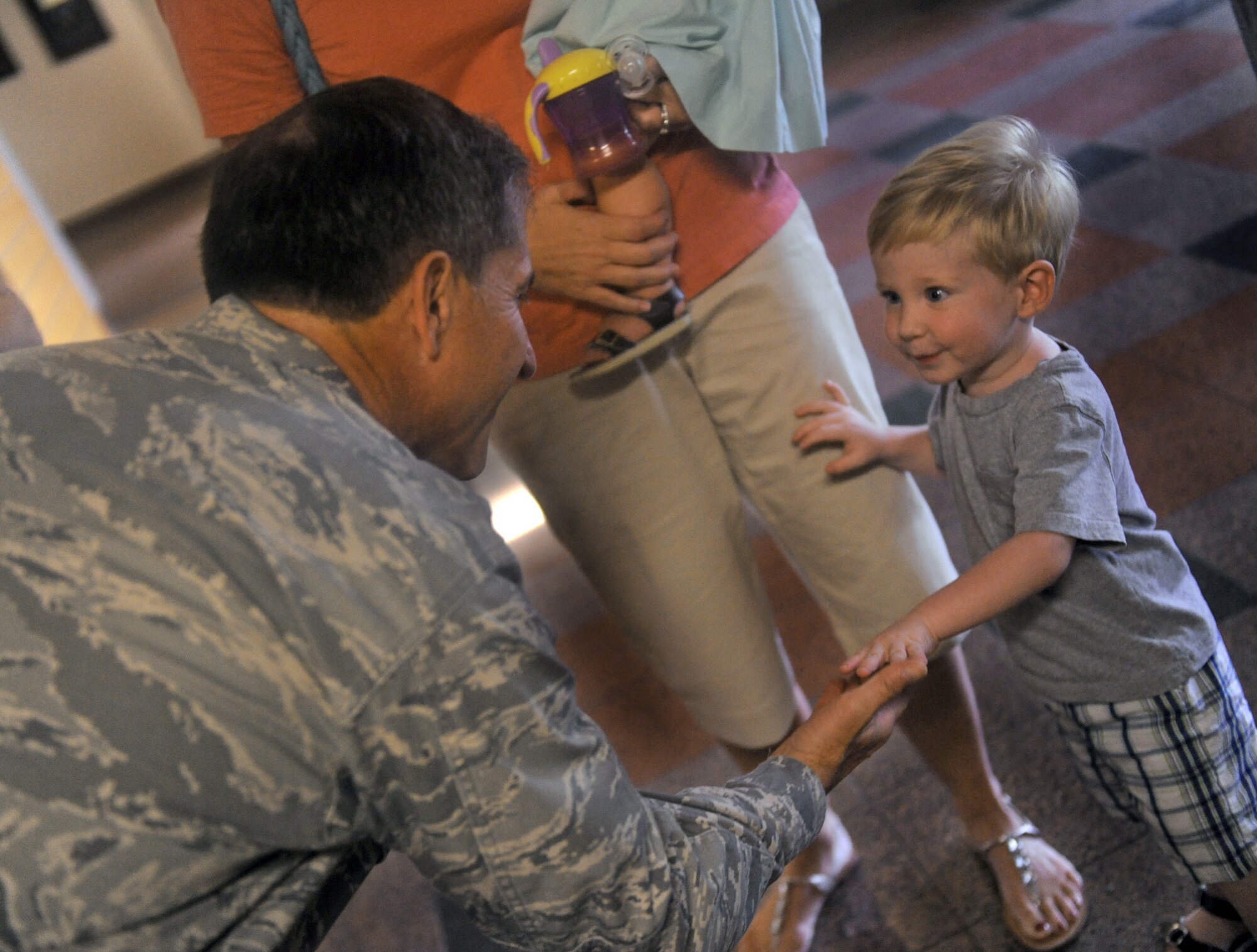 Maj. Gen. David Goldfein gives a high five to Noah Kunkel, the son of Lt. Col. Tom Kunkel, Sept. 1, 2010, during a visit to Moody Air Force Base, Ga. General Goldfein was rescued by Colonel Kunkel when his aircraft was shot down over enemy territory in May 1999. General Goldfein is the Air Combat Command director of air and space operations. Colonel Kunkel is the 41st Rescue Squadron commander. (U.S. Air Force photo/Airman 1st Class Benjamin Wiseman)
