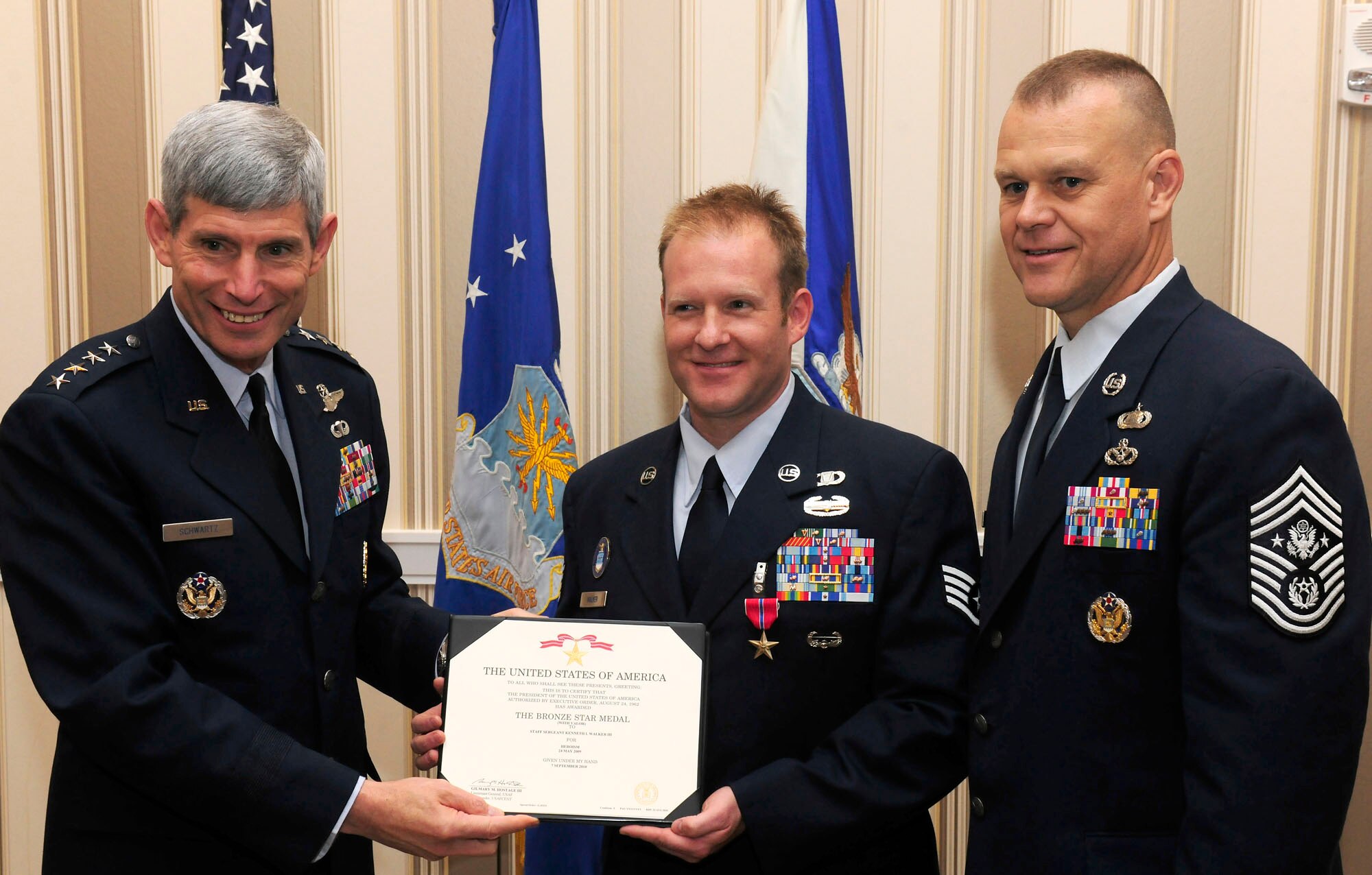 Air Force Chief of Staff Gen. Norton Schwartz and Chief Master Sgt. of the Air Force James Roy congratulate Staff Sgt. Kenneth I. Walker III after he was presented the Bronze Star with Valor Sept. 14, 2010, during the Air Force Association's Air and Space Conference and Technology Exposition at National Harbor in Oxon Hill, Md.  Sergeant Walker earned the award for heroism displayed during ground combat in Ghosleck Valley, Afghanistan. (U.S. Air Force photo/Scott M. Ash)
