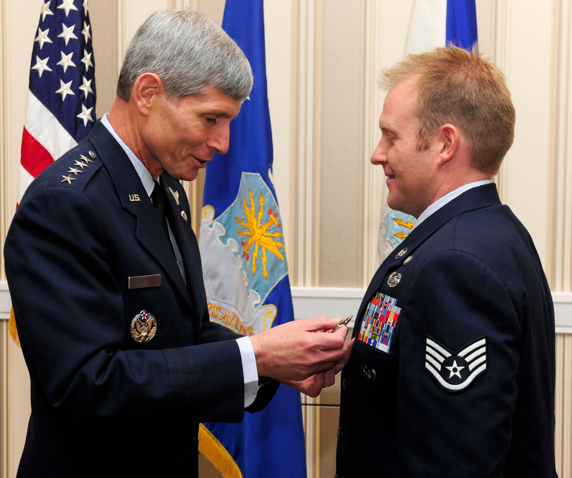 Air Force Chief of Staff Gen. Norton Schwartz pins the Bronze Star with Valor on Staff Sgt. Kenneth I. Walker III during the Air Force Association's Air and Space Conference and Technology Exposition Sept. 14, 2010, at National Harbor in Oxon Hill, Md. Sergeant Walker earned the award for heroism displayed during ground combat in Ghosleck Valley, Afghanistan. (U.S. Air Force photo/Scott M. Ash)
