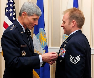 Air Force Chief of Staff Gen. Norton Schwartz pins the Bronze Star with Valor on Staff Sgt. Kenneth I. Walker III during the Air Force Association's Air and Space Conference and Technology Exposition Sept. 14, 2010, at National Harbor in Oxon Hill, Md. Sergeant Walker earned the award for heroism displayed during ground combat in Ghosleck Valley, Afghanistan. (U.S. Air Force photo/Scott M. Ash)
