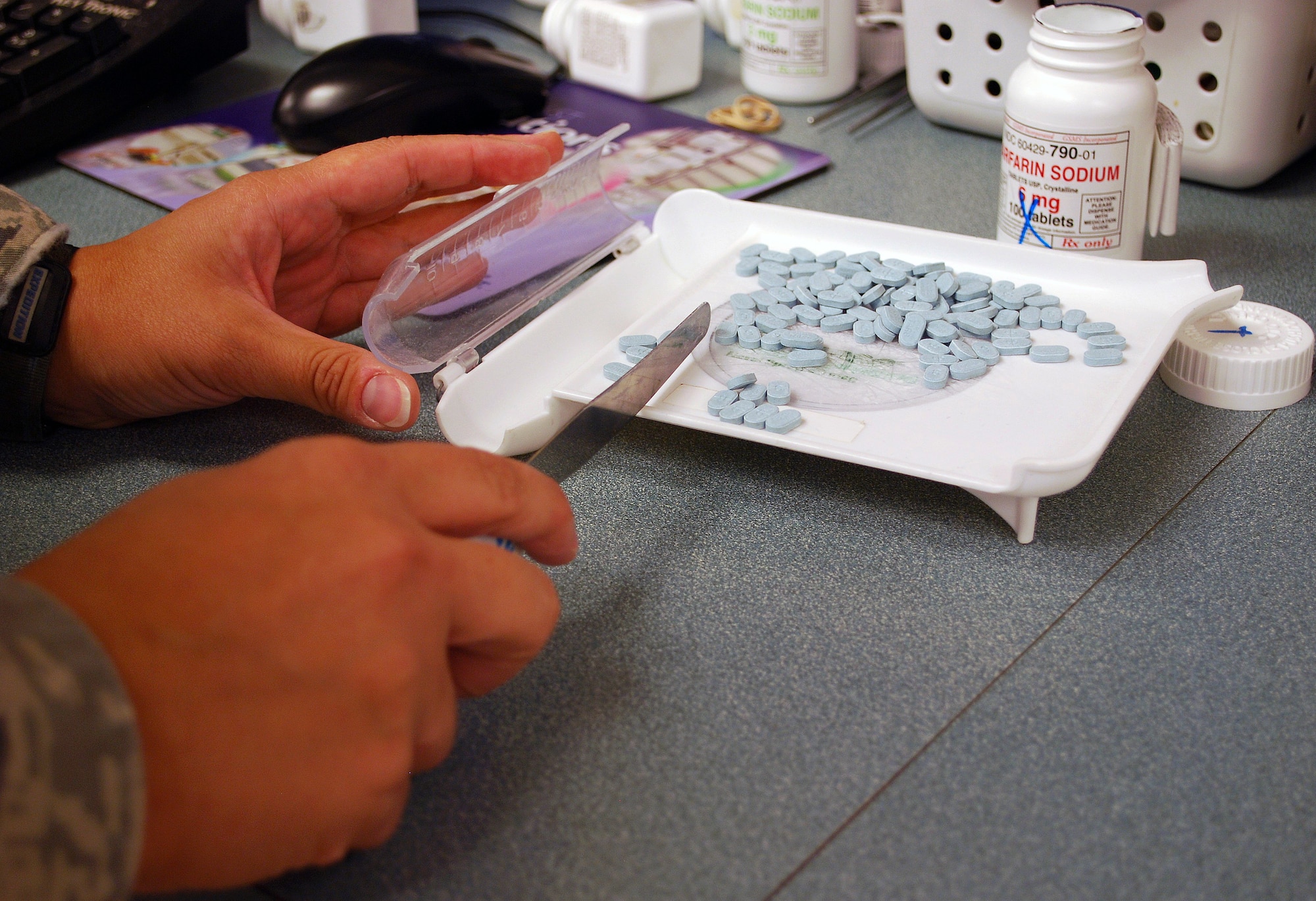 Maj. Melissa Pammer, 82nd Medical Support Squadron pharmacy flight commander, separates pills to be used in filling a prescription Sept. 14 at the pharmacy on Sheppard Air Force Base, Texas.  The Sheppard Pharmacy use both automated and manual methods to ensure patients receive the proper dosage prescribed for their treatment period.  (U.S. Air Force photo/Tech. Sgt. Vernon Cunningham)