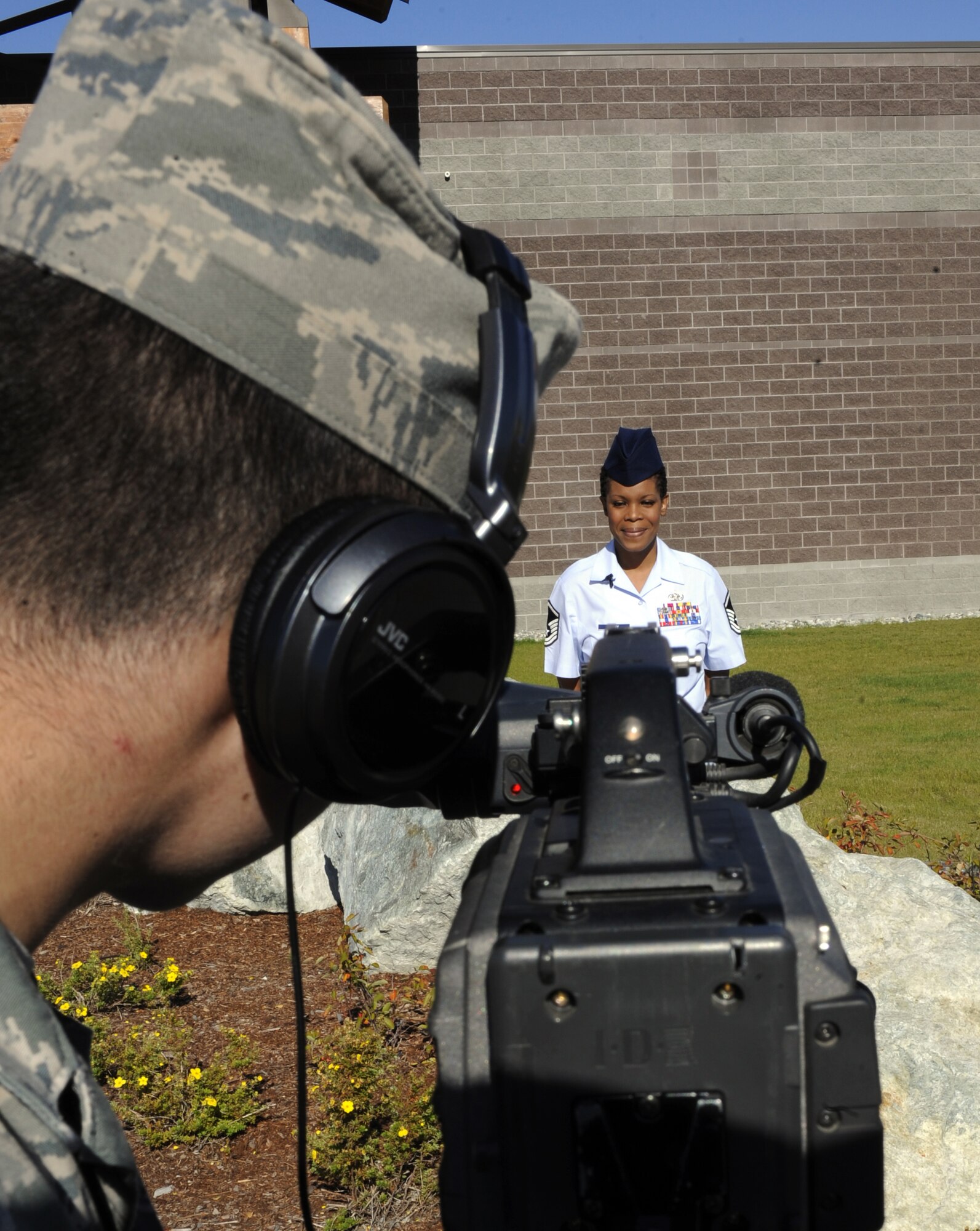 Master Sgt. Kerryann Daley gives a holiday greeting to her family Sept. 13, 2010, Eielson Air Force Base, Alaska. The joint hometown news service provides Airmen a way to send a holiday greeting to the family that is geographically separated from them. Sergeant Daley is the NCO in charge of inbound receiving assigned to the 354th Logistics Readiness Squadron. (U.S. Air Force photo/Senior Airman Willard E. Grande II)