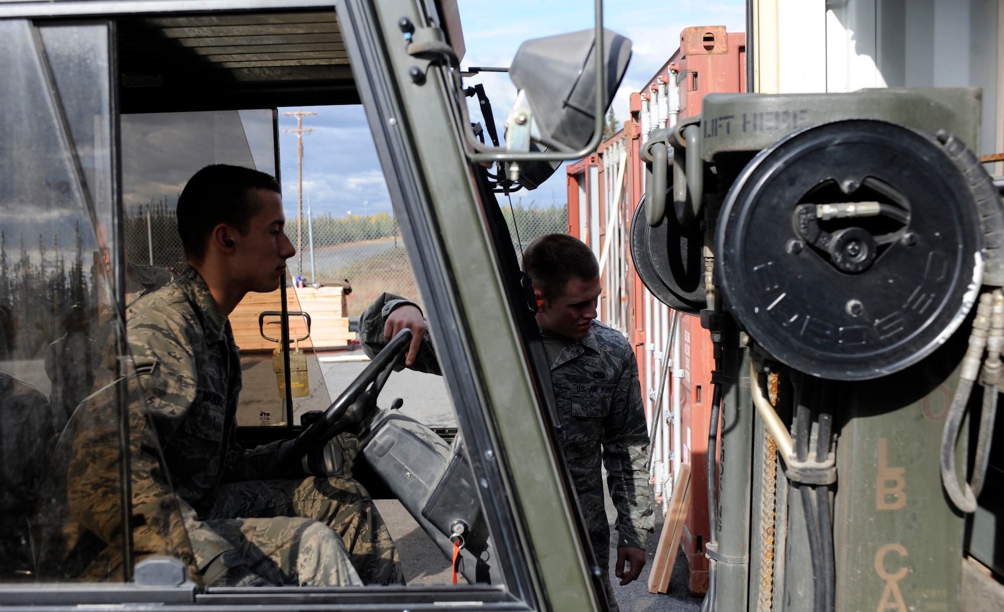 Senior Airman Robert Mastrangelo spots a forklift carrying unserviceable munitions into a shipping container Sept. 9, 2010, Eielson Air Force Base, Alaska. This shipment is headed to a barge where unserviceable munitions are sent back to the lower 48. Airman Mastrangelo is a crew member assigned to the 354th Munitions Storage Flight. (U.S. Air Force photo/Senior Airman Willard E. Grande II)