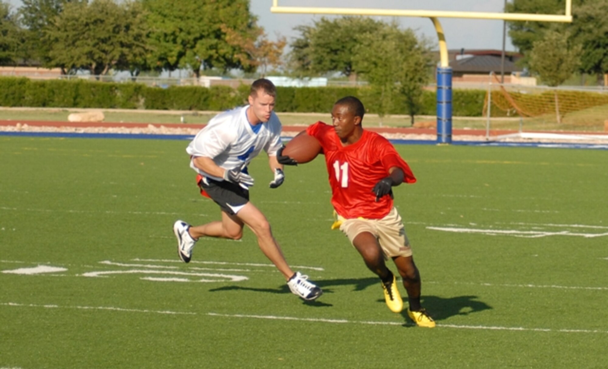 Keiyon Monroe, 17th Medical Group Cobras, tries to outrun 1st Responders player Robert Berry during an intramural football game Sept. 13. 1st Responders defeated the Cobras 21-20. (U.S. Air Force photo/Connie Hempel)