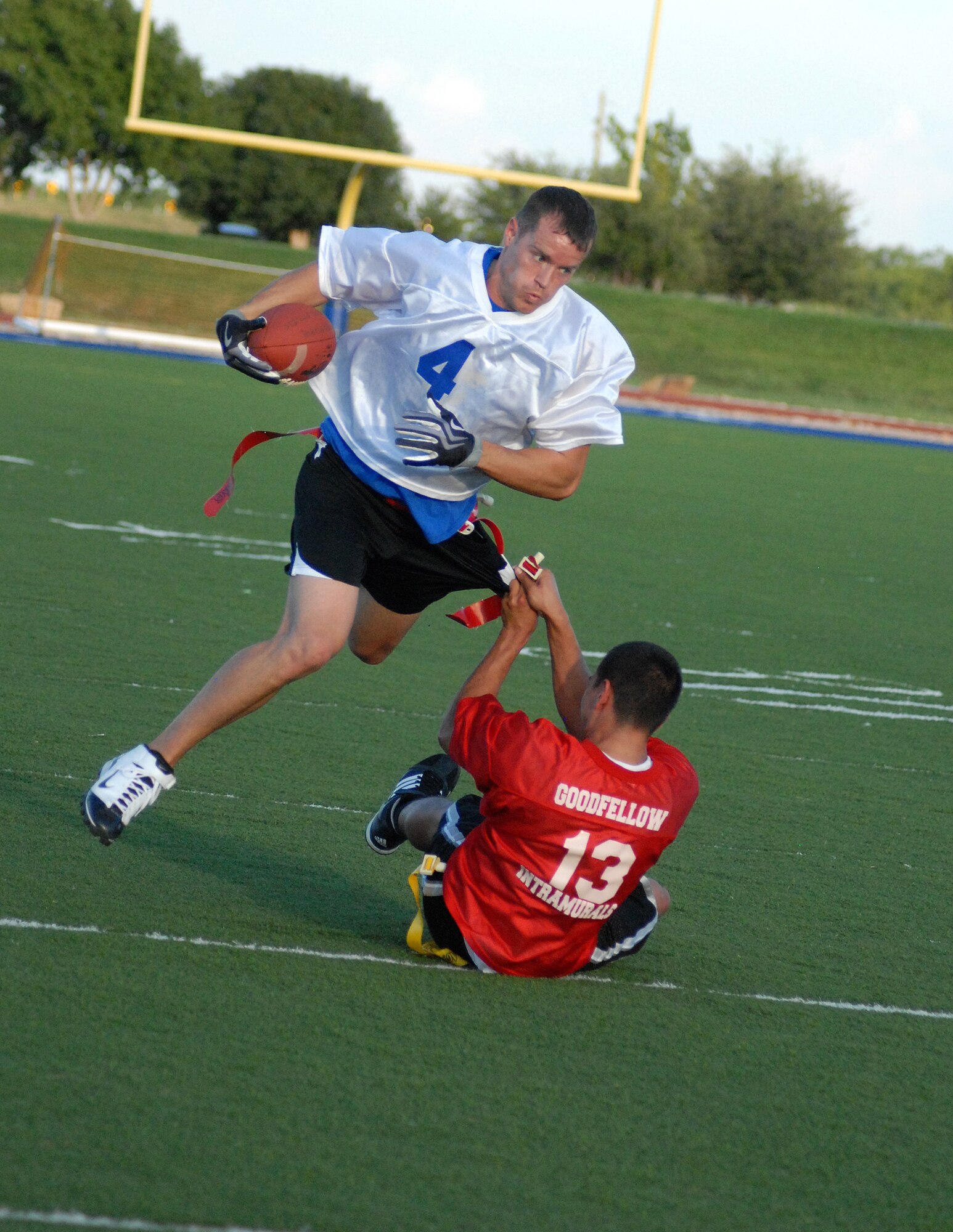 Geofrey Fortier, 17th Medical Group Cobras, pulls the flag off 1st Responders player Robert Berry during an intramural football game Sept. 13. 1st Responders defeated the Cobras 21-20. (U.S. Air Force photo/Connie Hempel)