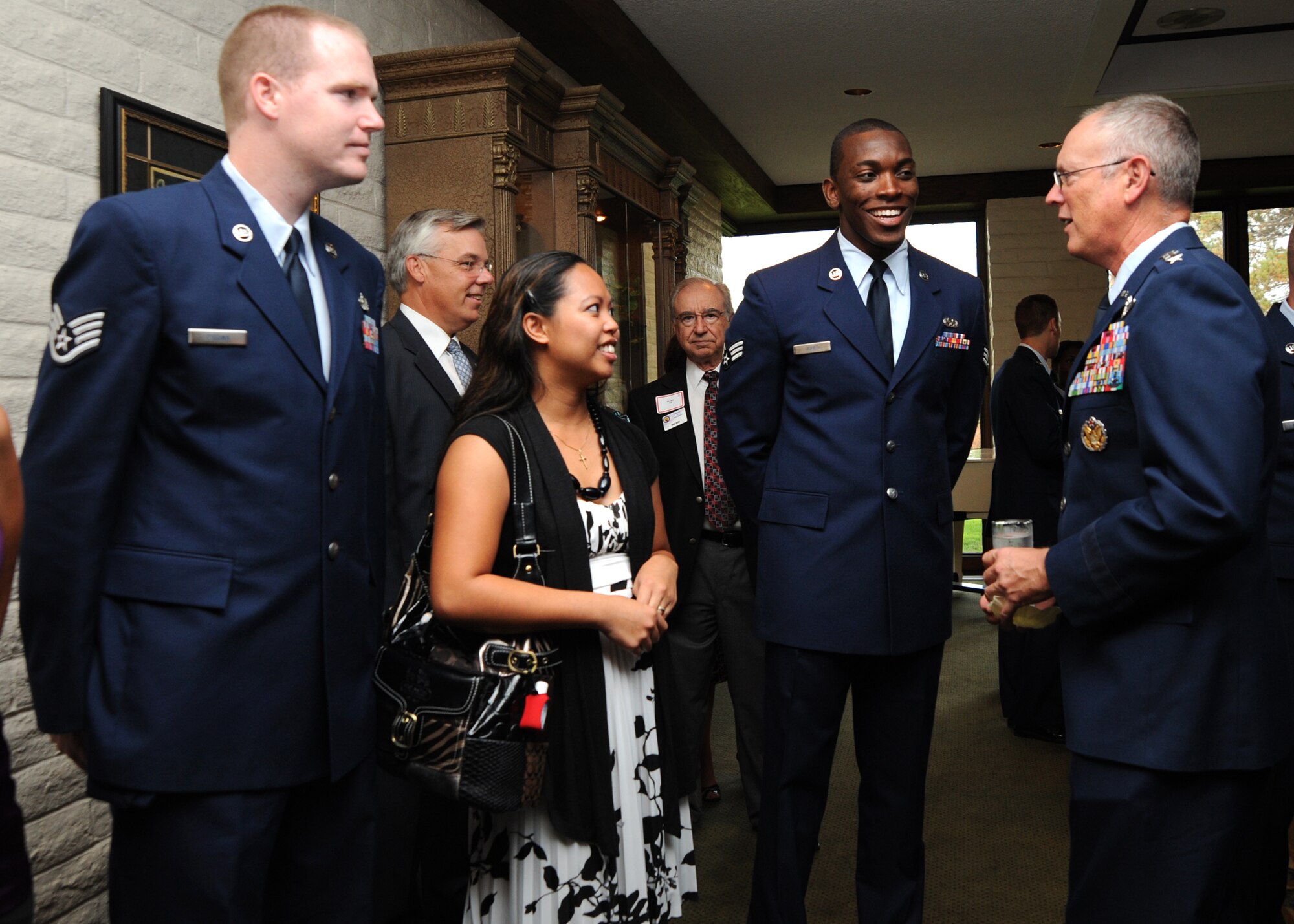 Lt. Gen. Robert Allardice, 18th Air Force commander, thanks Staff Sgt. Jonathan Cissna, 22nd Communications Squadron communication focal point technician, his wife Jona and Senior Airman Steven Jones, 22nd Aircraft Maintenance Squadron crew chief, for their contributions to the Air Mobility Command during a dinner titled “Ordinary Airmen, Extraordinary Actions,” at the Crestview Country Club, Sept. 8, 2010, Wichita, Kan.  The 18th Air Force commander visited McConnell Sept. 8 through 9, and met with Airmen to show his appreciation for their work, particularly their contributions to Air Mobility Command. (U.S. Air Force photo/Airman 1st Class Andrea Salazar)