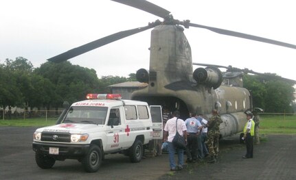 BLUEFIELDS, Nicaragua --  Medics transport a sick baby onto a 1-228th Aviation Regiment CH-47 Chinook helicopter for evacuation to a hospital in Managua, Nicaragua, here Sept. 9. The team was unable to use a medical evacuation Blackhawk helicopter for transportation because the baby was in a large incubator. The Chinook crew was able to get the baby and his family safely to Mangua for treatment. (Photo by 1st Lt. Mike Jeter)