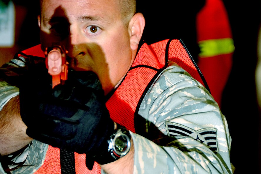OFFUTT AIR FORCE BASE, Neb. - Air Force Reserve Staff Sgt. Shawn McKenna, 55th Secrurity Forces Squadron, watches closely as he monitors a hallway in the base’s main customer support building as part of an active shooter exercise Sept. 10.  Team Offutt’s first responders conduct various exercise scenarios throughout the year to prepare for possible threats to people and resources. U.S. Air Force photo by Jeff W. Gates