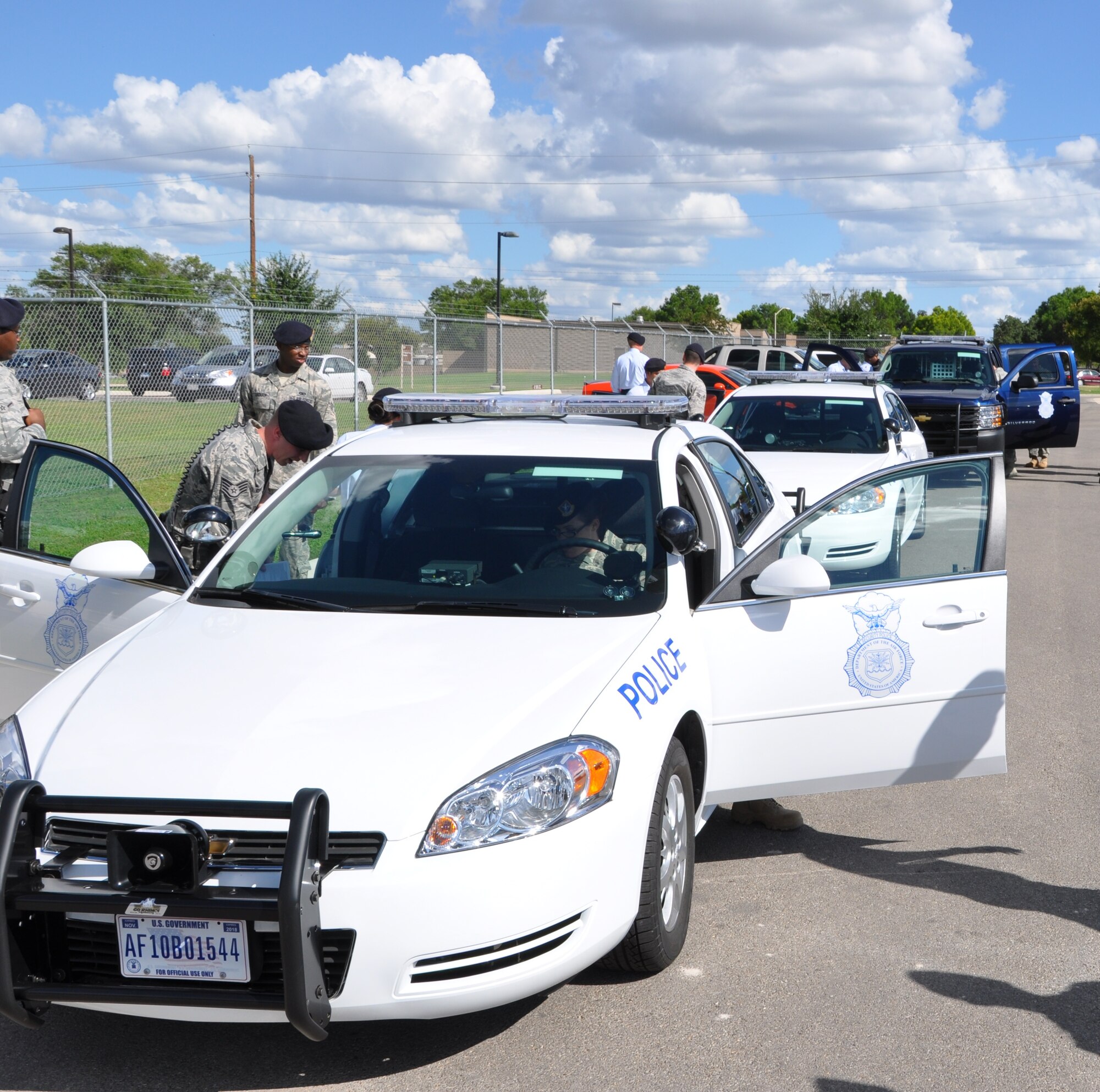 LAUGHLIN AIR FORCE BASE, Texas – Airmen from the 47th Security Forces Squadron investigate the brand new cars that were presented to them by Col. Michael Frankel, 47th Flying Training Wing commander, here Sept. 13. Colonel Frankel said the cars were a small token to show how much the 47th SFS is appreciated. (U.S. Air Force photo by Airman 1st Class Blake Mize)