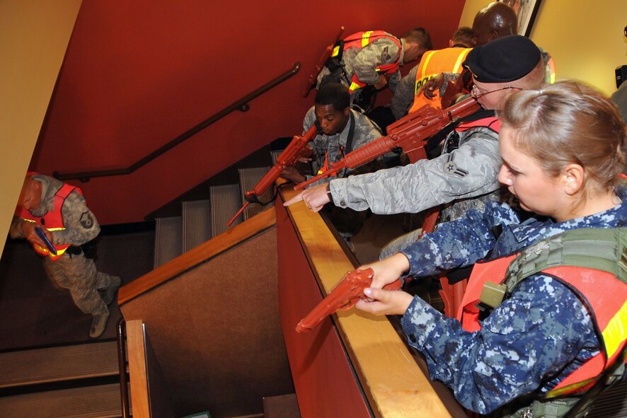OFFUTT AIR FORCE BASE, Neb. - Members of the 55th Secrurity Forces Squadron secure a stairway in the base’s main customer support building Sept. 10 as part of an active shooter exercise.  Team Offutt’s first responders conduct various exercises throughout the year to prepare for possible threats to people and resources. U.S. Air Force photo by Jeff W. Gates