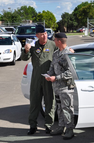 LAUGHLIN AIR FORCE BASE, Texas – Col. Michael Frankel, 47th Flying Training Wing commander, surprises Senior Airman (select) Gregory Booth, 47th Security Forces Squadron, with his new stripes after he was selected for Senior Airman Below the Zone here Sept. 13. The BTZ program allows select Airmen to advance in rank to senior airman six months early. (U.S. Air Force photo by Airman 1st Class Blake Mize)