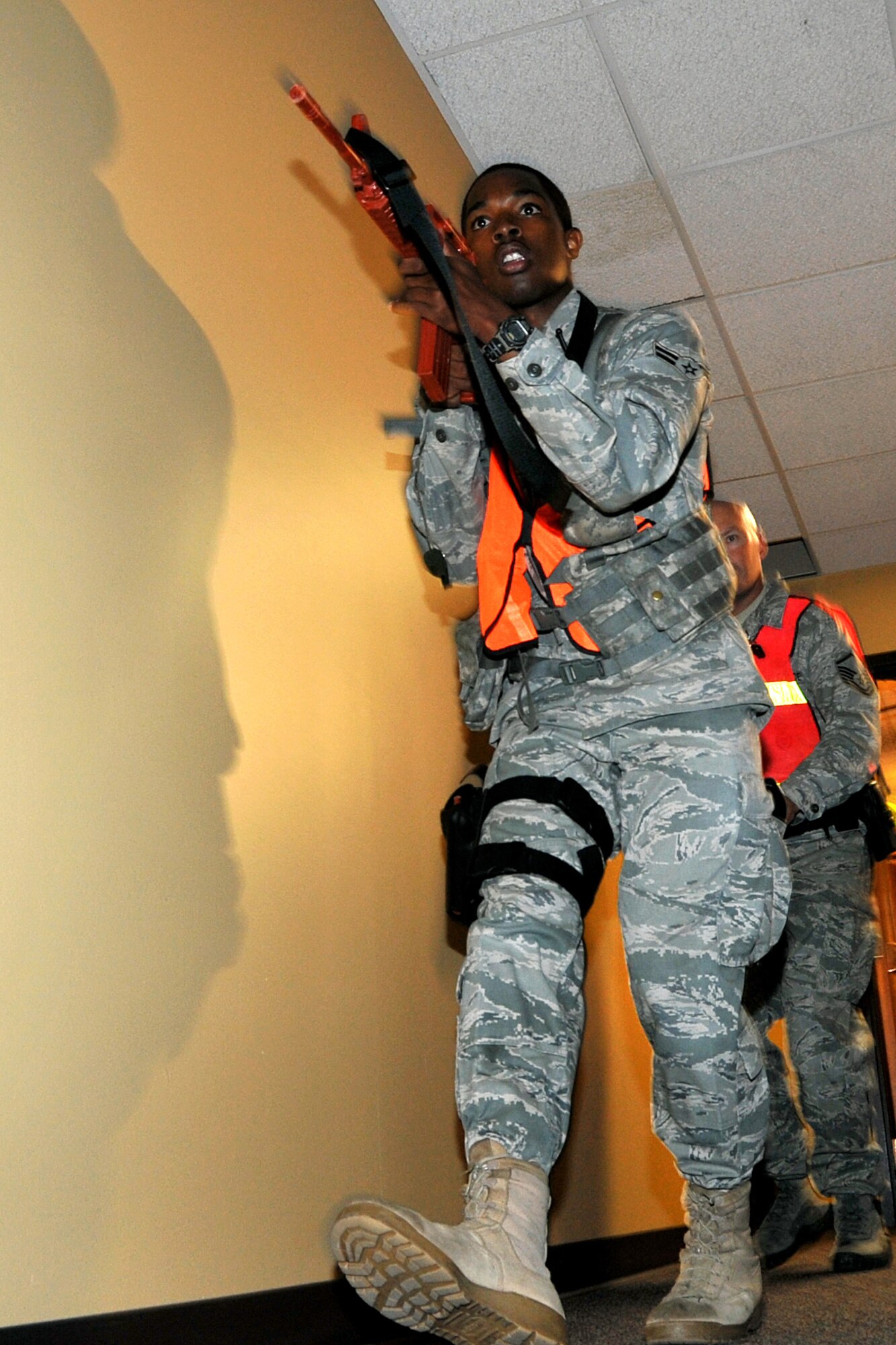 OFFUTT AIR FORCE BASE, Neb. - Airman 1st Class Randy Dotson, 55th Security Forces Squadron, follows teammates down a hallway in the base's main customer support building.  Team Offutt's first responders conduct various exercise scenarios throughout the year to prepare for possible threats to people and resources. U.S. Air Force photo by Jeff W. Gates