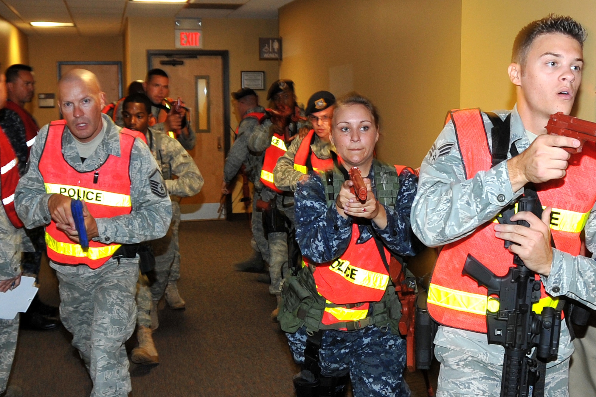 OFFUTT AIR FORCE BASE, Neb. - Members of the 55th Secrurity Forces Squadron walk secure a hallway in the base's main customer support building as part of an active shooter exercise Sept. 10.  Team Offutt's first responders conduct various exercise scenarios throughout the year to prepare for possible threats to people and resources. U.S. Air Force Photo by Jeff W. Gates