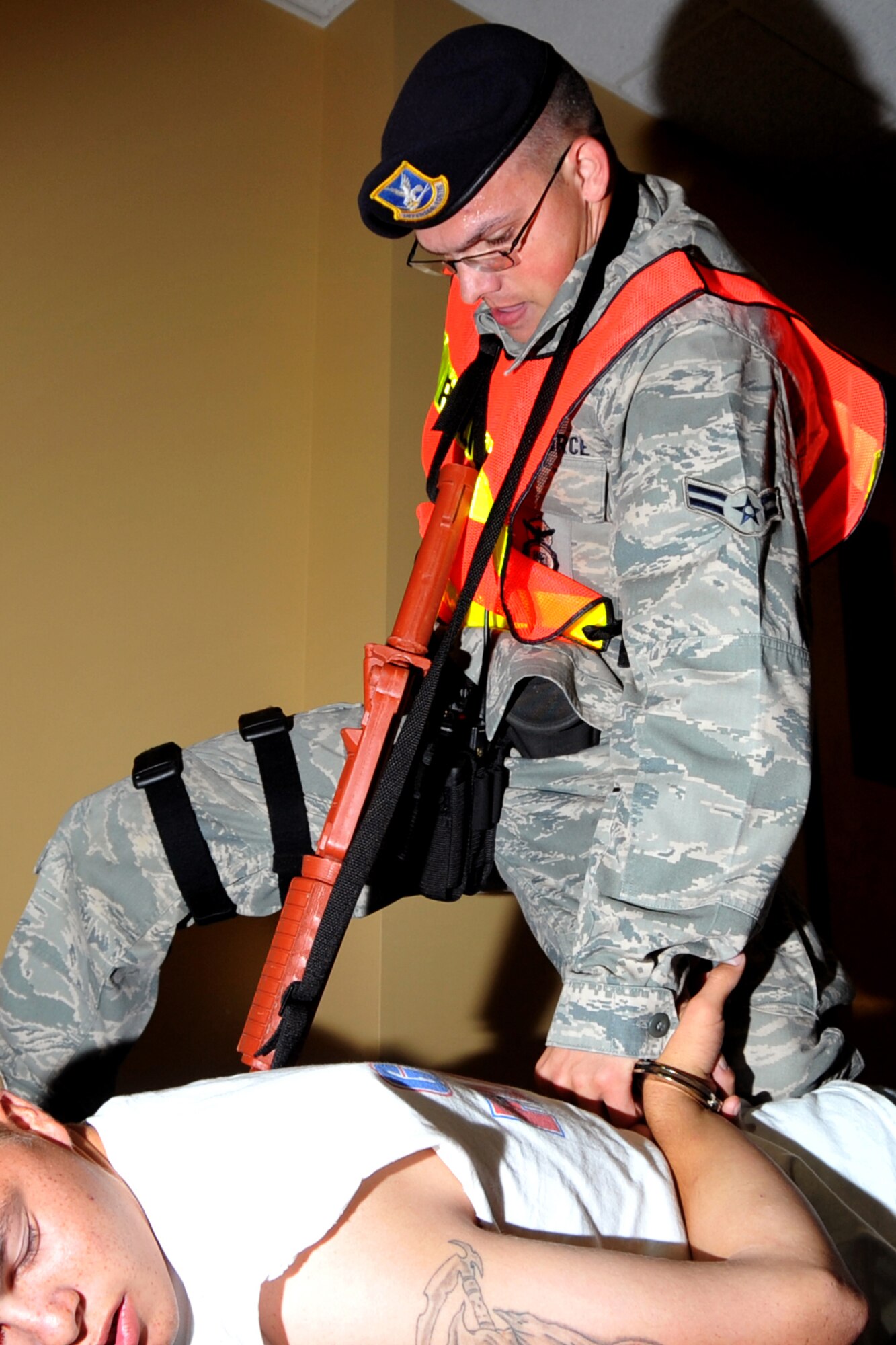 OFFUTT AIR FORCE BASE - Airman 1st Class Robert Freewalt detains simulated shooter Airman 1st Class Daniel Martinez, both members of the 55th Security Forces Squadron, during an active shooter exercise Sept. 10 in the base's main customer support building.  Team Offutt's first responders conduct various exercise scenarios throughout the year to prepare for possible threats to people and resources. U.S. Air Force photo by Jeff W. Gates