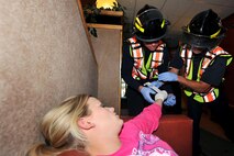 OFFUTT AIR FORCE BASE, Neb. - Members from the 55th Civil Engineer Squadron bandage a simulated hand wound on Senior Airman Ashley Robinson, 55th Force Support Squadron, during an active shooter exercise Sept .10. in  the base's main customer support building.  Team Offutt's first responders conduct various exercise scenarios throughout the year to prepare for possible threats to people and resources. U.S. Air Force photo by Charles Haymond