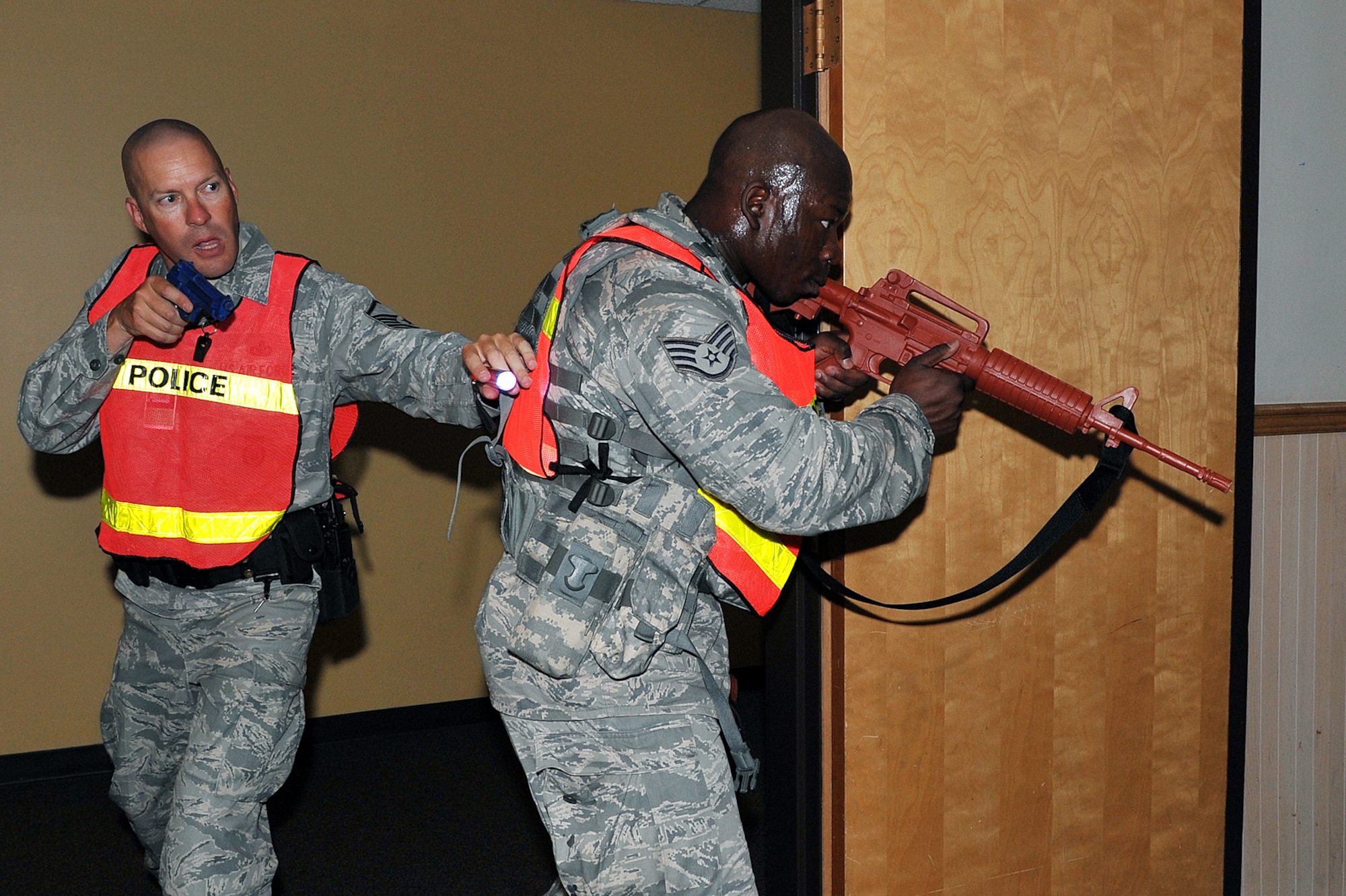 OFFUTT AIR FORCE BASE, Neb. - Master Sgt. Steven Flamming and Staff Sgt. Marcus Stokes, 55th Security Forces Squadron, scan a room inside Bldg. C during an active shooter exercise Sept. 10. Building C is the base's main customer support building. Team Offutt's first responders conduct various exercise scenarios throughout the year to prepare for possible threats to people and resources. U.S. Air Force photo by Charles Haymond