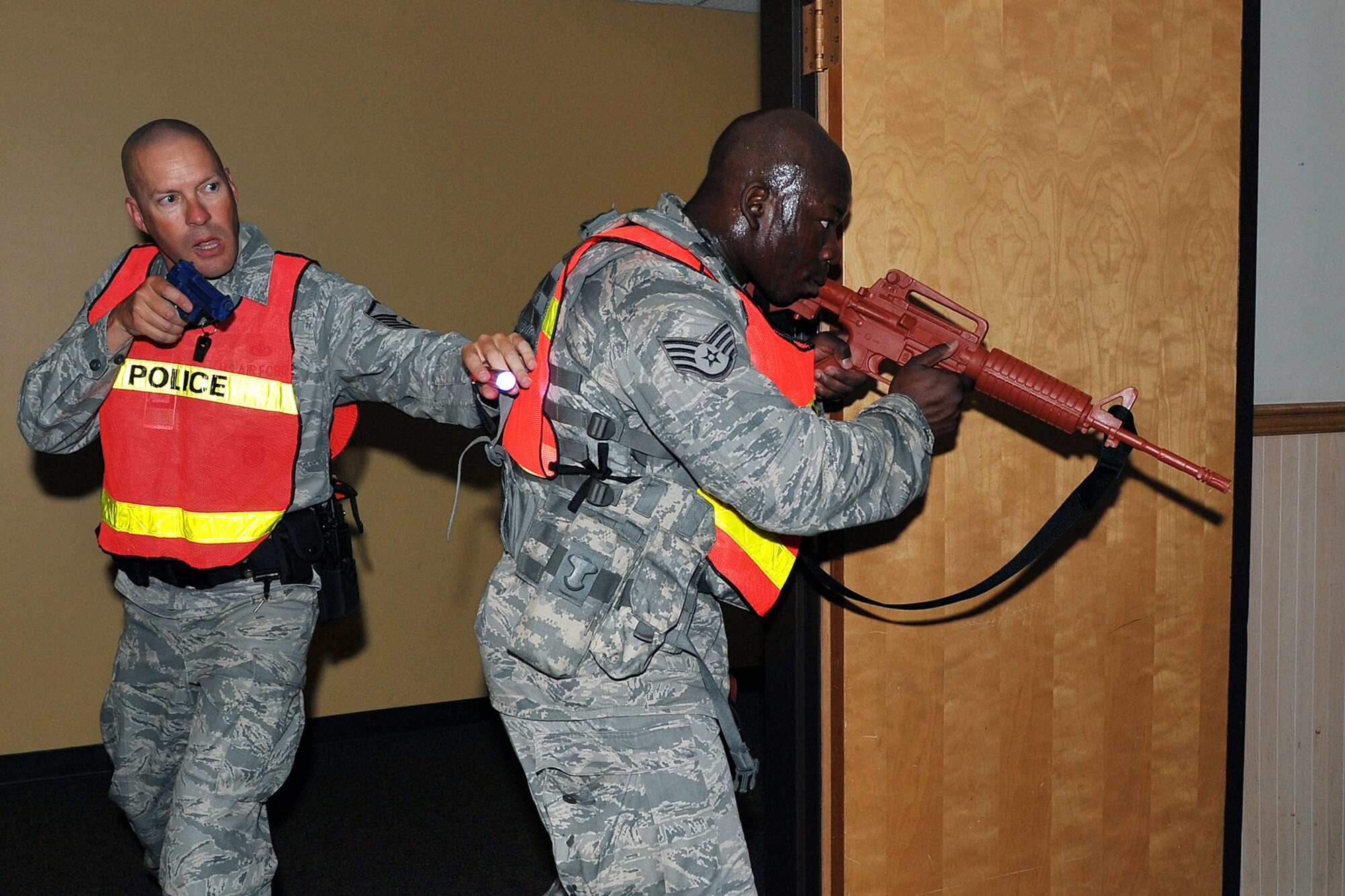 OFFUTT AIR FORCE BASE, Neb. - Master Sgt. Steven Flamming and Staff Sgt. Marcus Stokes, 55th Security Forces Squadron, scan a room inside Bldg. C during an active shooter exercise Sept. 10. Building C is the base's main customer support building. Team Offutt's first responders conduct various exercise scenarios throughout the year to prepare for possible threats to people and resources. U.S. Air Force photo by Charles Haymond