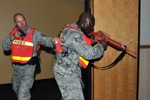 OFFUTT AIR FORCE BASE, Neb. - Master Sgt. Steven Flamming and Staff Sgt. Marcus Stokes, 55th Security Forces Squadron, scan a room inside Bldg. C during an active shooter exercise Sept. 10. Building C is the base's main customer support building. Team Offutt's first responders conduct various exercise scenarios throughout the year to prepare for possible threats to people and resources. U.S. Air Force photo by Charles Haymond