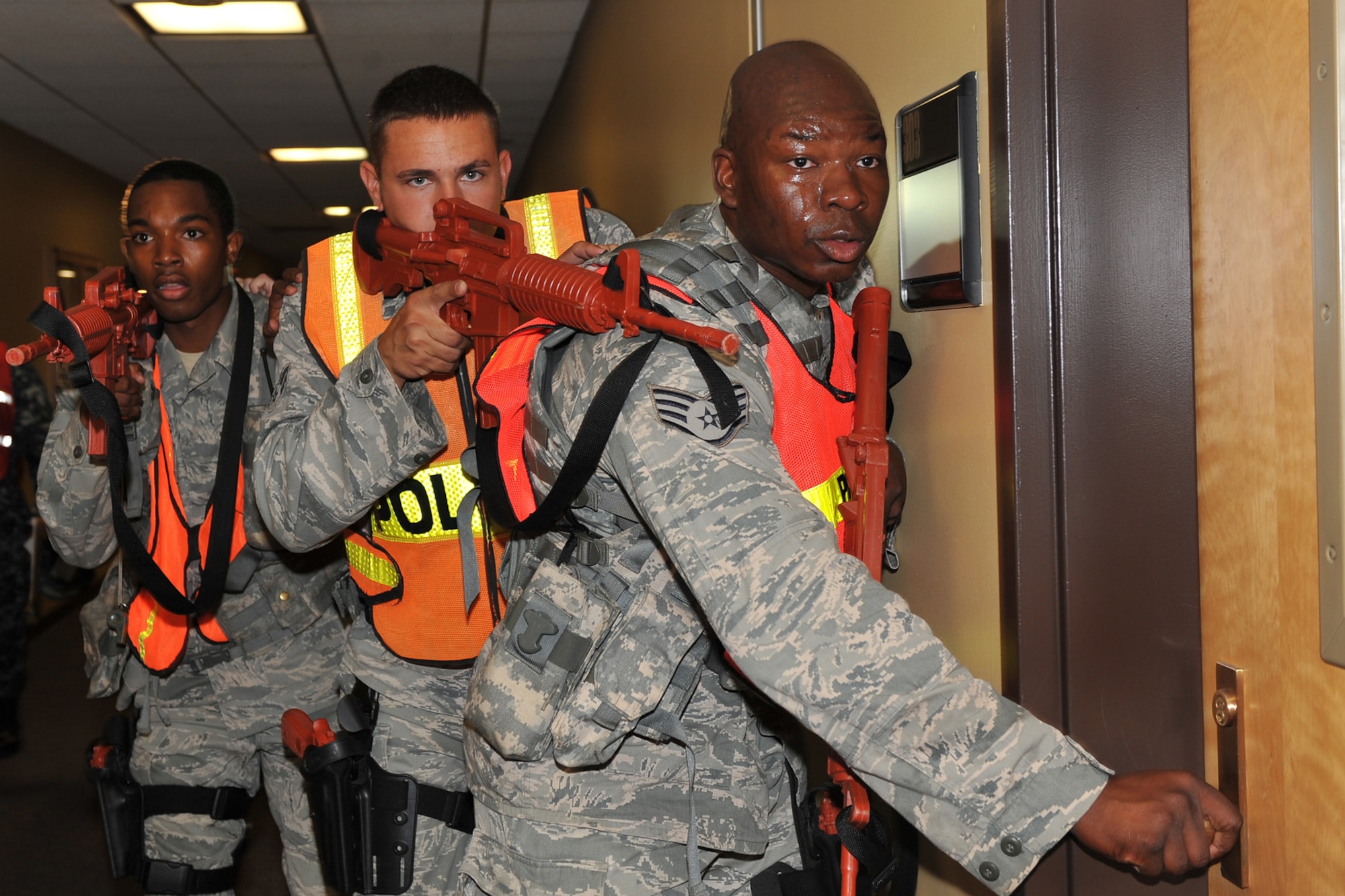 OFFUTT AIR FORCE BASE, Neb. - Team members from the 55th Security Forces Squadron check the doors during an active shooter exercise Sept. 10 in base's main customer support building.  Team Offutt's first responders conduct various exercise scenarios throughout the year to prepare for possible threats to people and resources. U.S. Air Force photo by Charles Haymond