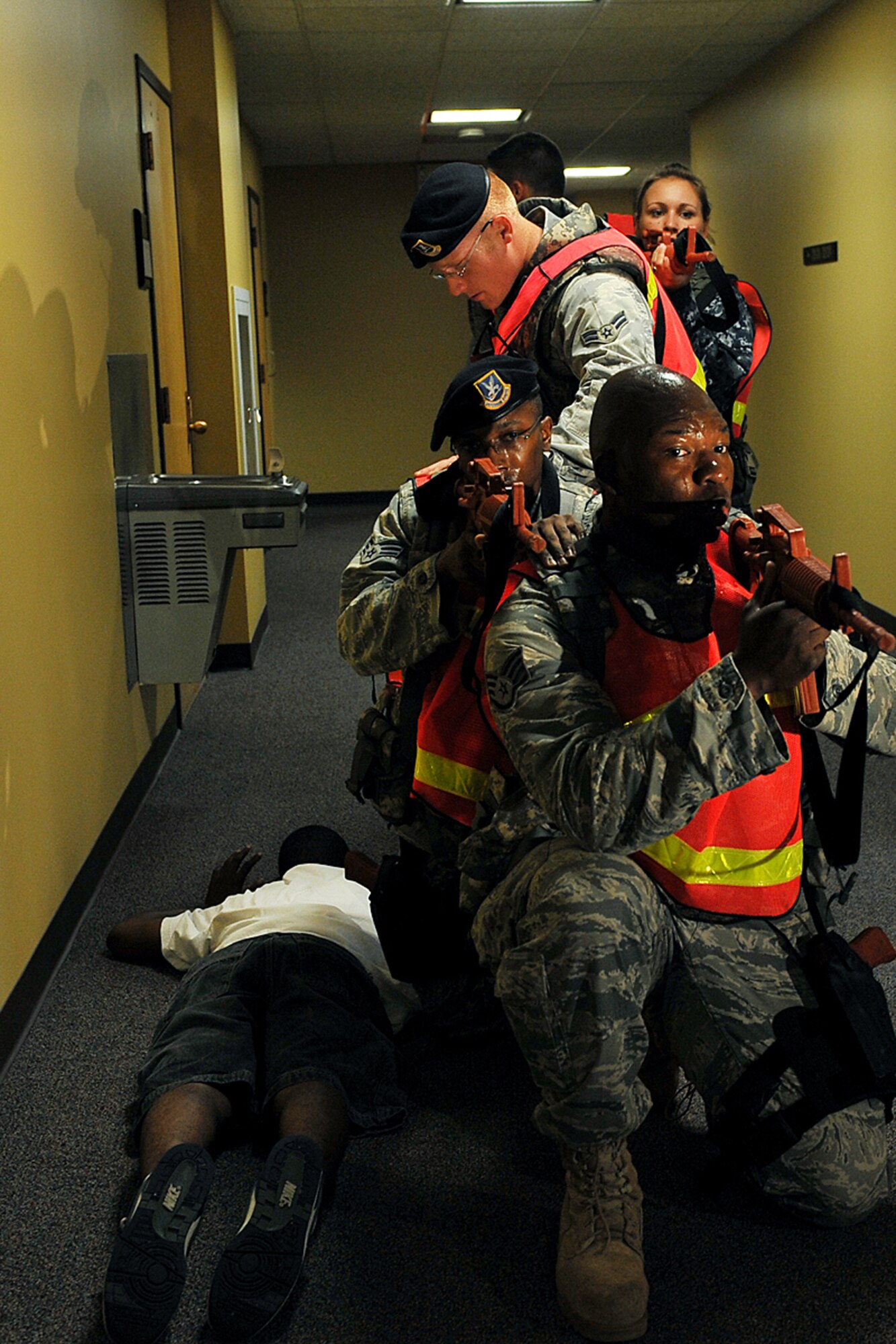 OFFUTT AIR FORCE BASE, Neb. - Team members from the 55th Security Forces Squadron scan the hallways during an active shooter exercise Sept. 10 in the base's main customer support building.  Team Offutt's first responders conduct various exercise scenarios throughout the year to prepare for possible threats to people and resources. U.S. Air Force photo by Charles Haymond