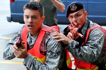OFFUTT AIR FORCE BASE, Neb. - Senior Airman Michael Snyder and Airman 1st Class Robert Freewalt, 55th Security Forces Squadron, draw their weapons during an active shooter exercise Sept. 10 in the base's main customer support building.  Team Offutt's first responders conduct various exercise scenarios throughout the year to prepare for possible threats to people and resources. U.S. Air Force photo by Charles Haymond