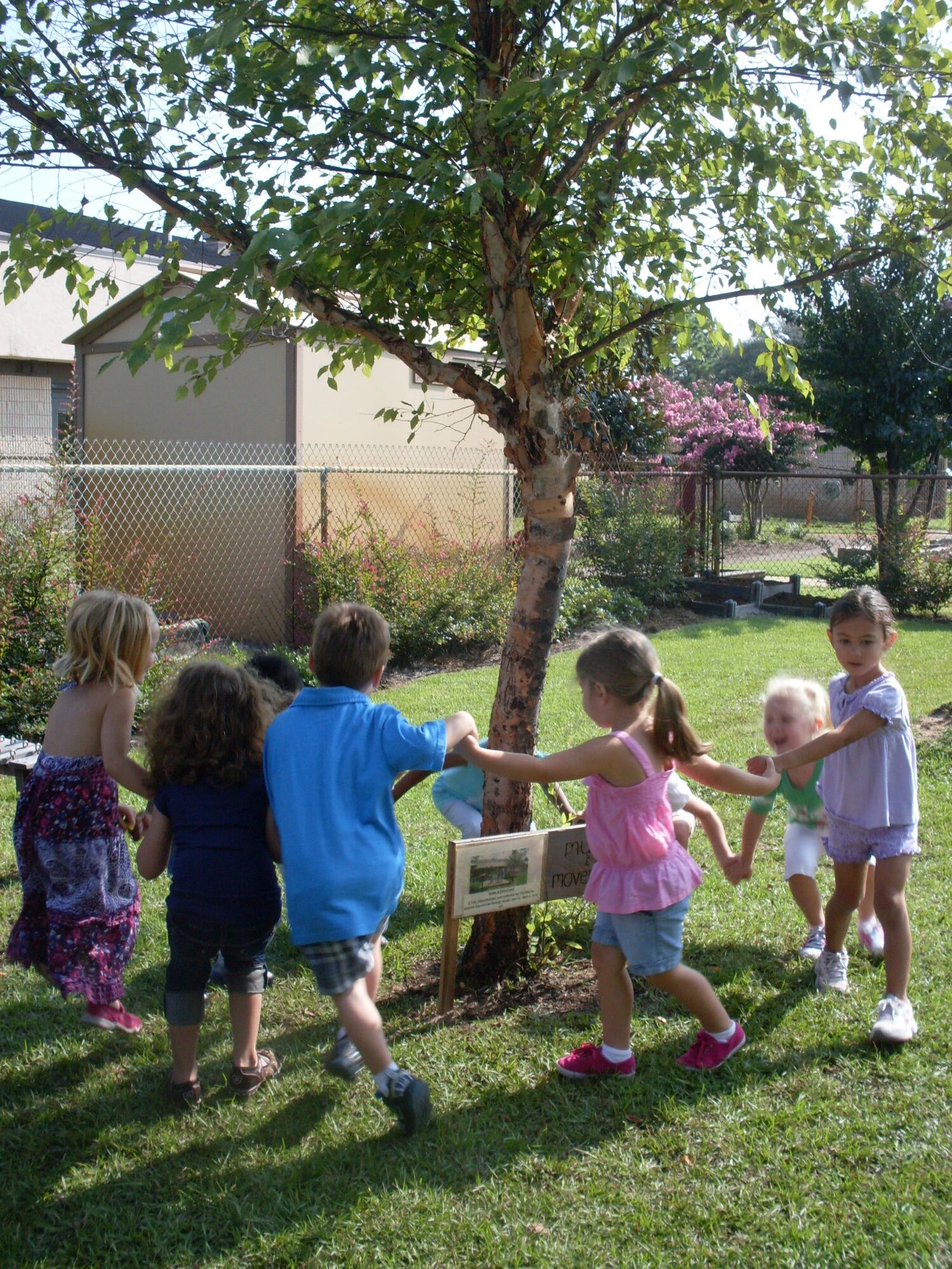 Children from the voluntary pre-kindergarten class play around a tree at the outdoor classroom at the Child Development Center at Hurlburt Field, Fla., Aug. 26, 2010. The CDC's classroom became the 50th classroom in the nation to be certified by the Arbor Day Foundation and Dimensions Educational Research Foundation Aug. 19. (Courtesy photo)