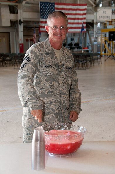 Chief Master Sergeant Steve Hampton stirs punch for the Manitenance Operations Flight Change of Command Ceremony, Saturday, September 11, 2010, at Rosecrans Airport, 139th Airlift Wing, Missouri Air National Guard, St. Joseph, Mo. 2nd Lt. James Tutusek takes command of the Maintenance Operations Flight from Major Mark Cheney.  (U.S. Air Force photo by Airman 1st Class Kelsey Stuart) (RELEASED)