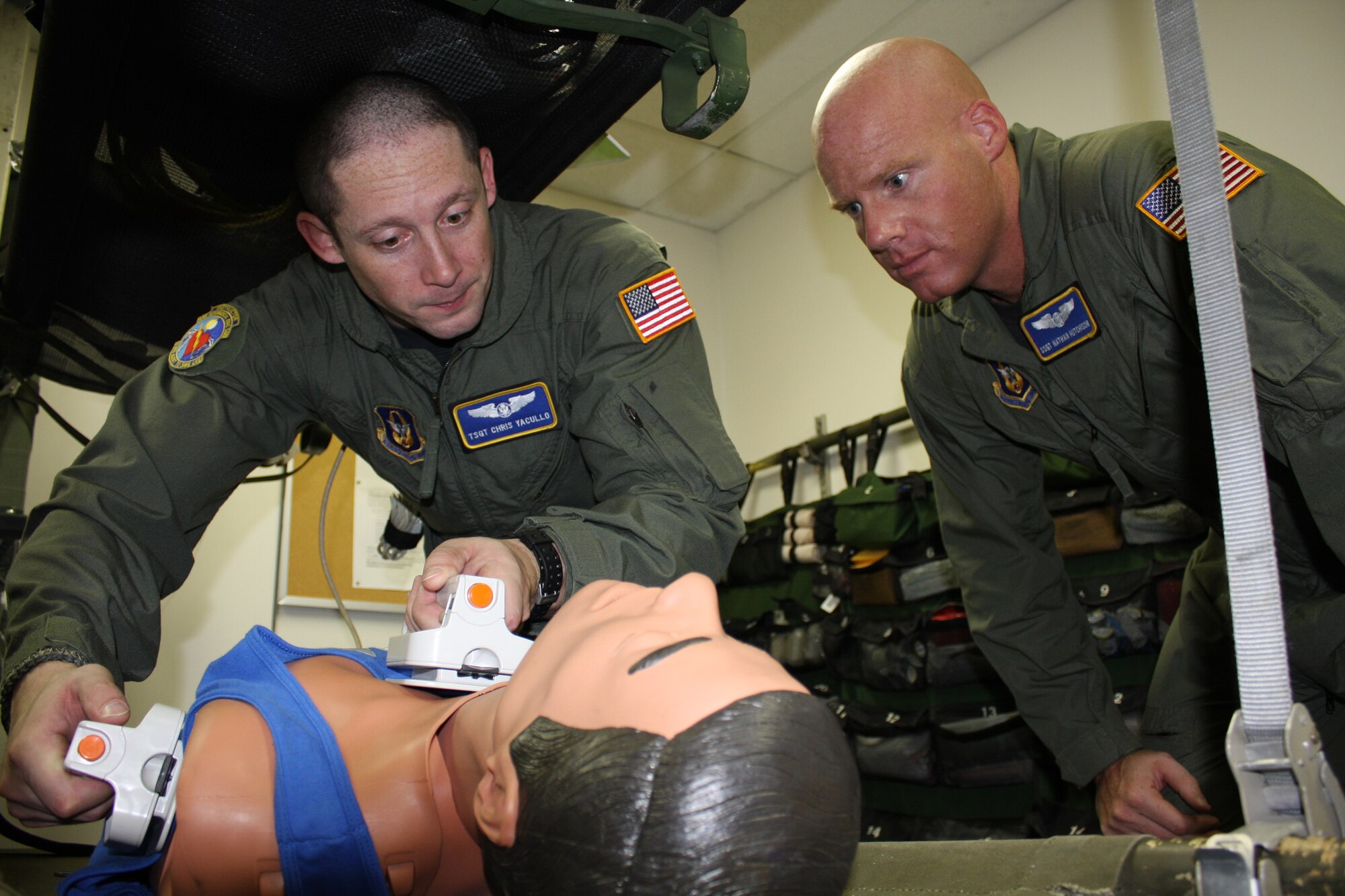 WRIGHT-PATTERSON AIR FORCE BASE, Ohio - Tech. Sgt. Chris Yacullo, 445th Aeromedical Evacuation Squadron, reviews procedures for emergency defibrillation on a "patient" while Staff Sgt. Nathan Hutchinson, 445 AES, observes.