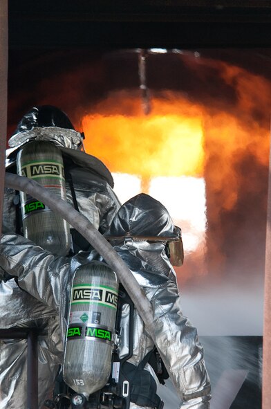 Members of the 139th Airlift Wing, Missouri Air National Guard fire department, extinguish a simulated aircraft fire on September 11, 2010, at Whiteman Air Force Base MO. The simulated fires are part of the fire fighters annual training. (U.S. Air Force photo by Senior Airman Sheldon Thompson/Released)