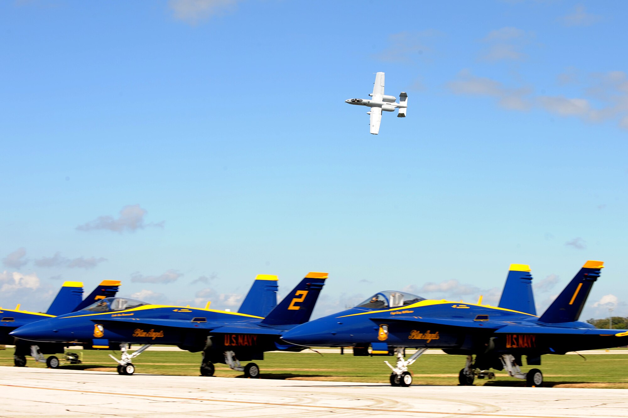 An A-10 Thunderbolt flies above Scott AFB and the Navy Blue Angels during the 2010 Airpower Over the Midwest Air Show held Sept. 11. The event featured planes in the sky and planes on the ground along with many other displays showcasing military power from the past and present. (U.S. Air Force photo by Staff Sgt. Brian J. Valencia)