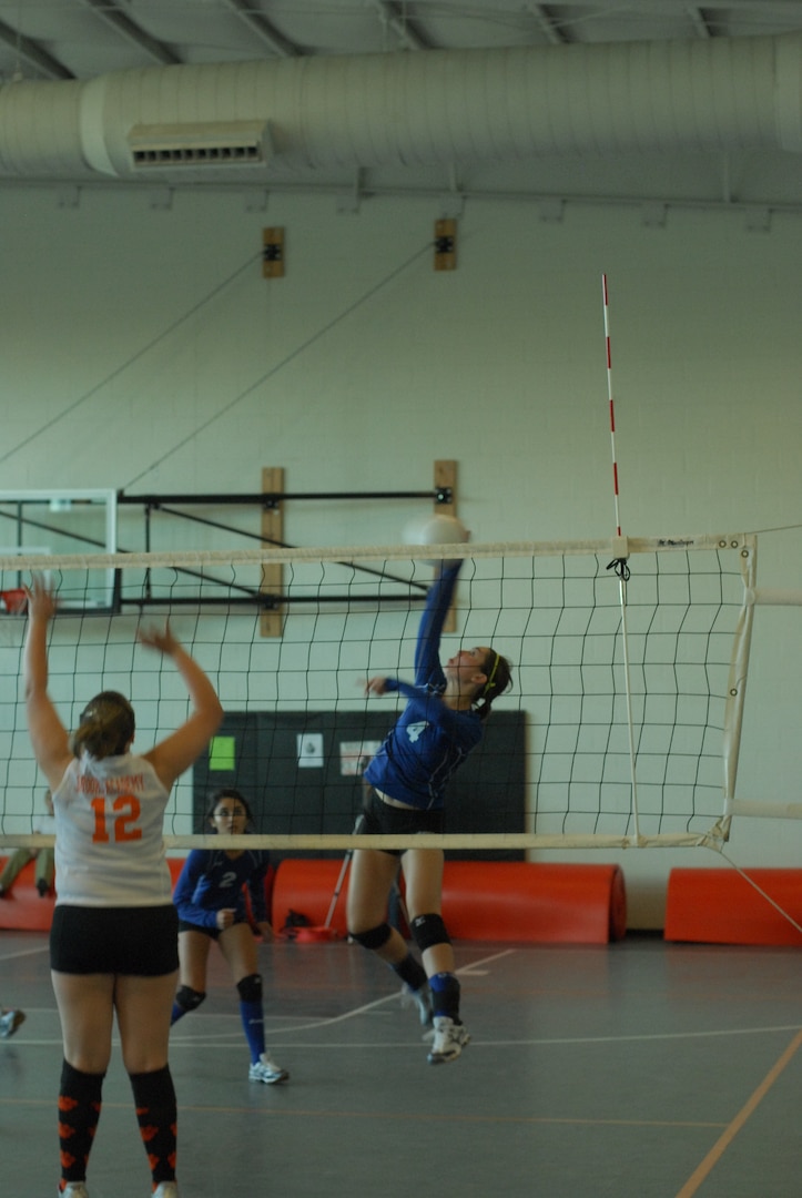 Randolph High School Ro-Hawks play Brooks Academy, beating them with a final score of 4-1. The Ro-Hawks are nealy unbeaten with a 6-1 record so far. Sophmore Natalie Nowland slams the ball over the net. (U.S. Air Force Photo/Brian McGloin)