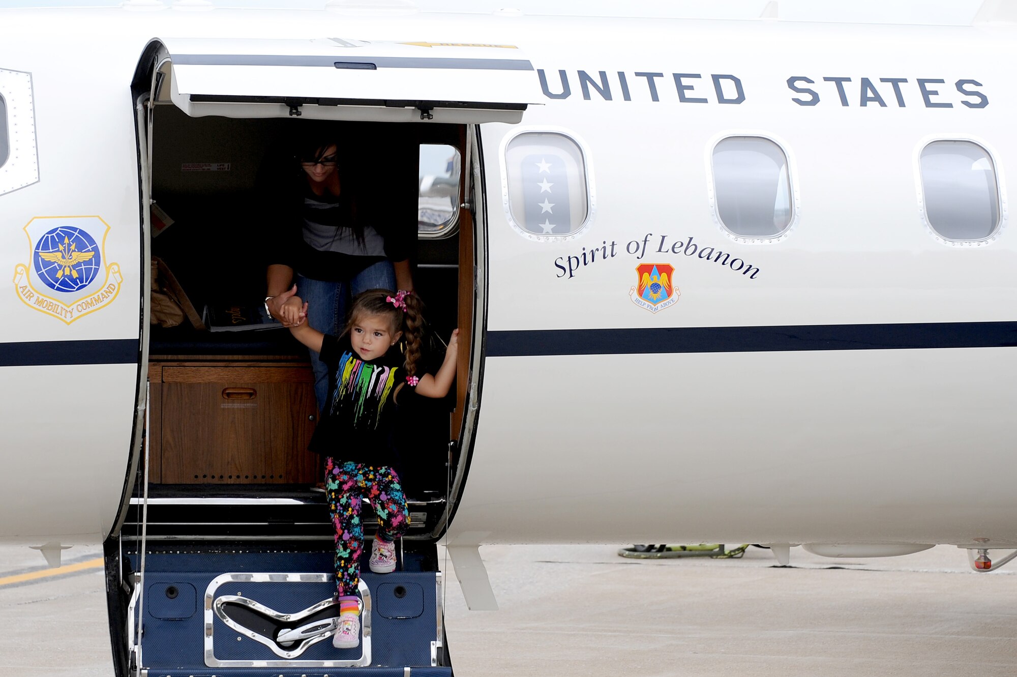 A child leads her mother off a C-21 static display at the 2010 Airpower Over the Midwest Air Show held Sept. 11 at Scott AFB. The event featured planes in the sky and planes on the ground along with many other displays showcasing military power from the past and present. (U.S. Air Force photo by Staff Sgt. Brian J. Valencia)