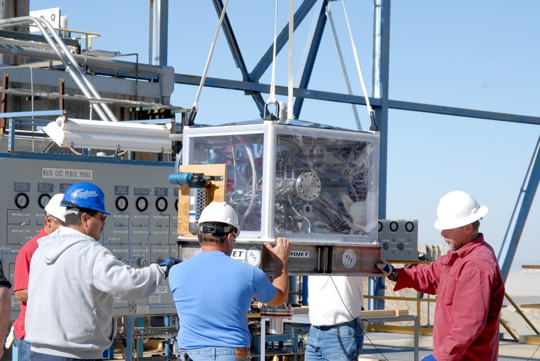 Air Force Research Laboratory workers use a crane to remove a newly delivered Upper Stage Engine Technology turbo pump from its shipping crate. The USET turbo pump will be connected to AFRL's 2A rocket test stand where it will undergo a series of tests using liquid hydrogen. (U.S. Air Force photo/Kenji Thuloweit)

