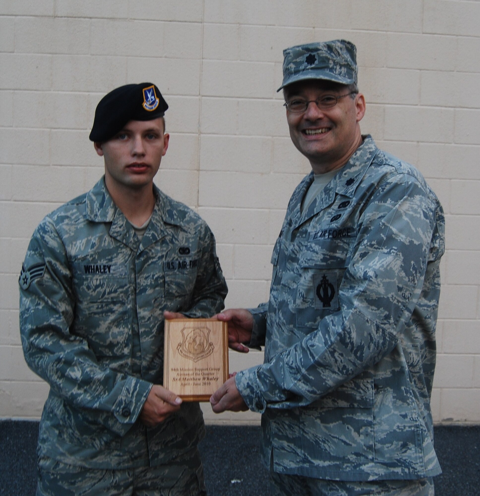 Lt. Col. Todd Laughman, 94 MSG/CC, presents a 2nd quarter winner's plaque to Senior Airman Matthew Whaley, 94 SFS, for the period covering April through June 2010.